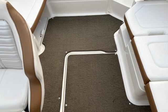 2017 Searay SPX210 boat interior with brown carpet and white seating.