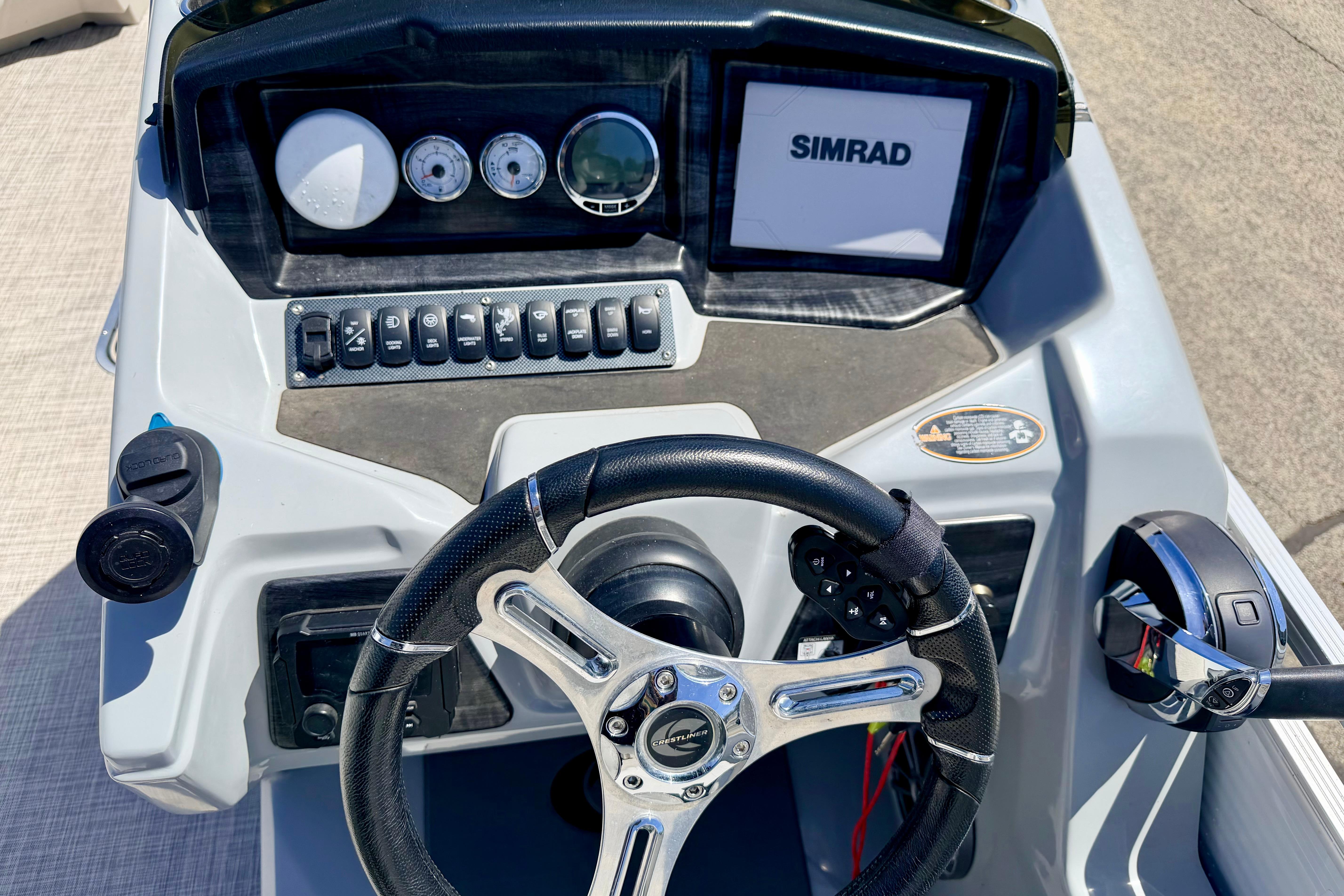 Steering console of 2019 Crestliner 240 Rally DX CW with Simrad display and controls.