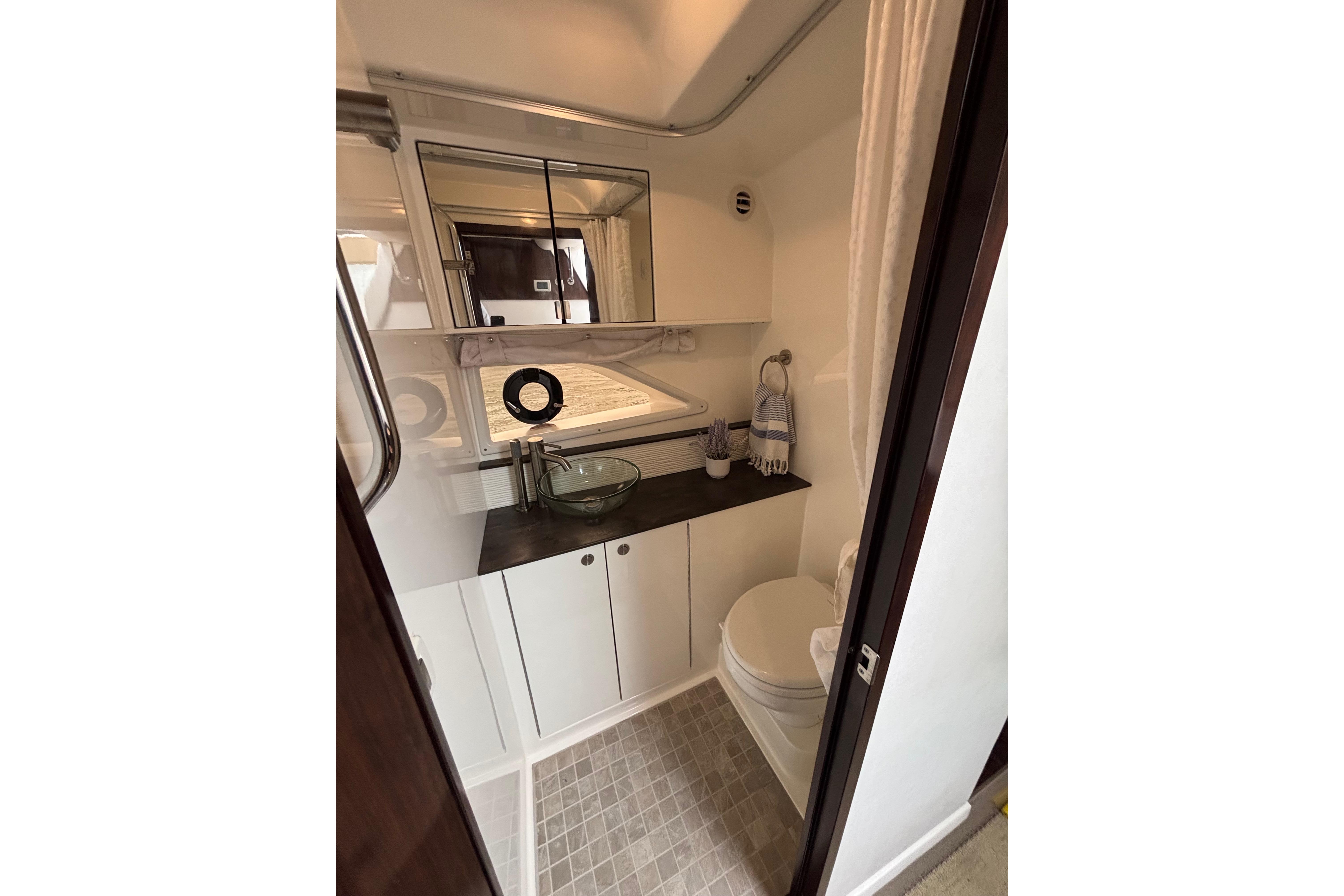 2021 Sea Ray Sundancer 320 Outboard bathroom with modern fixtures and compact design.