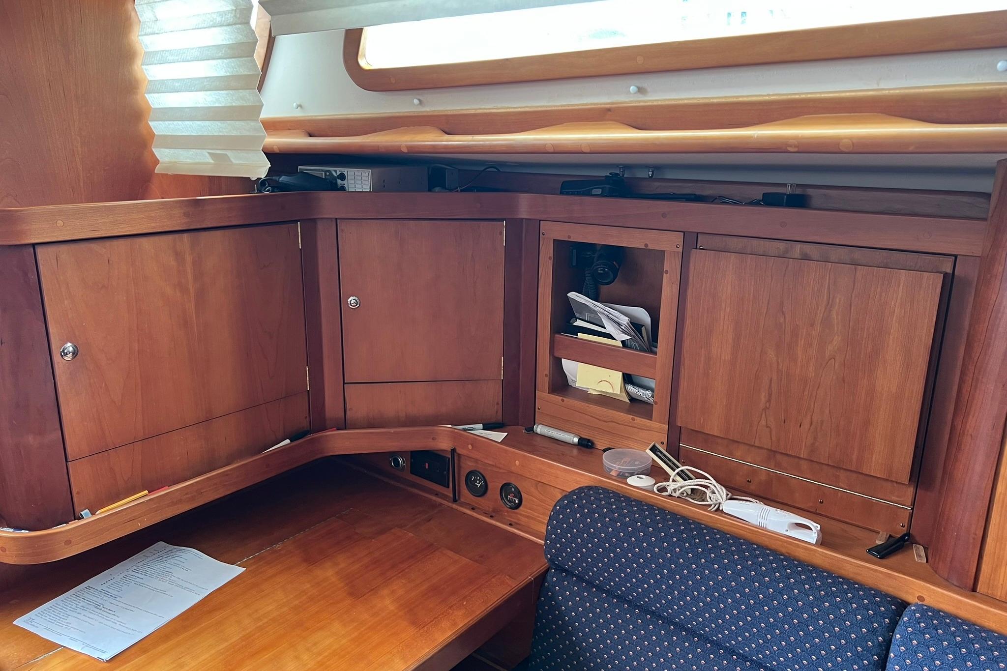 Interior of a 1998 Sabre 362 sailboat with wooden cabinetry and seating area.