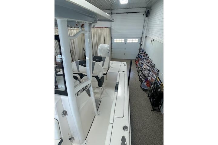 2024 Robalo 246 Cayman boat in indoor showroom, side view.