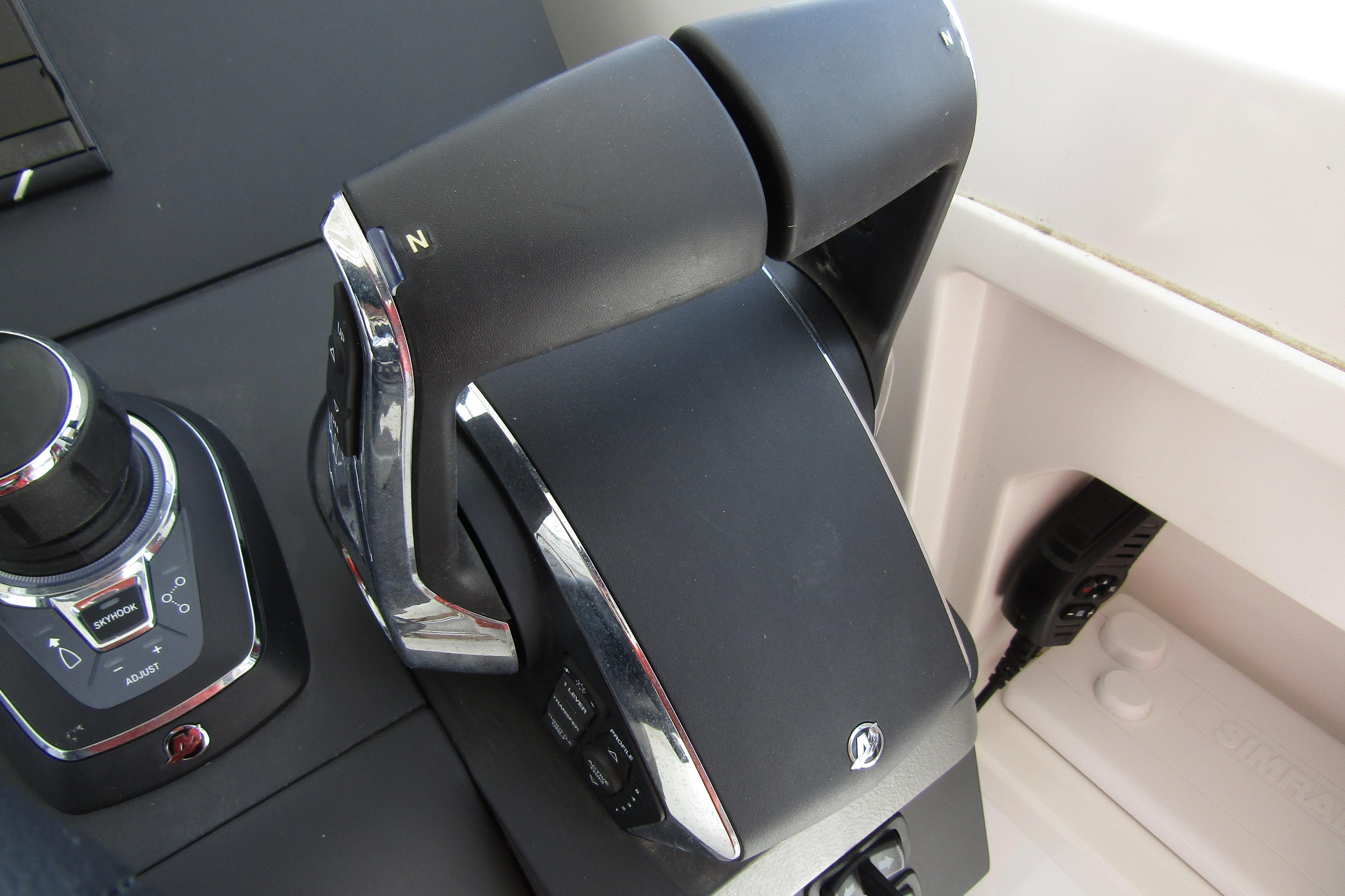 Control panel of 2025 Nimbus Tender 11 boat, featuring throttle and joystick controls.