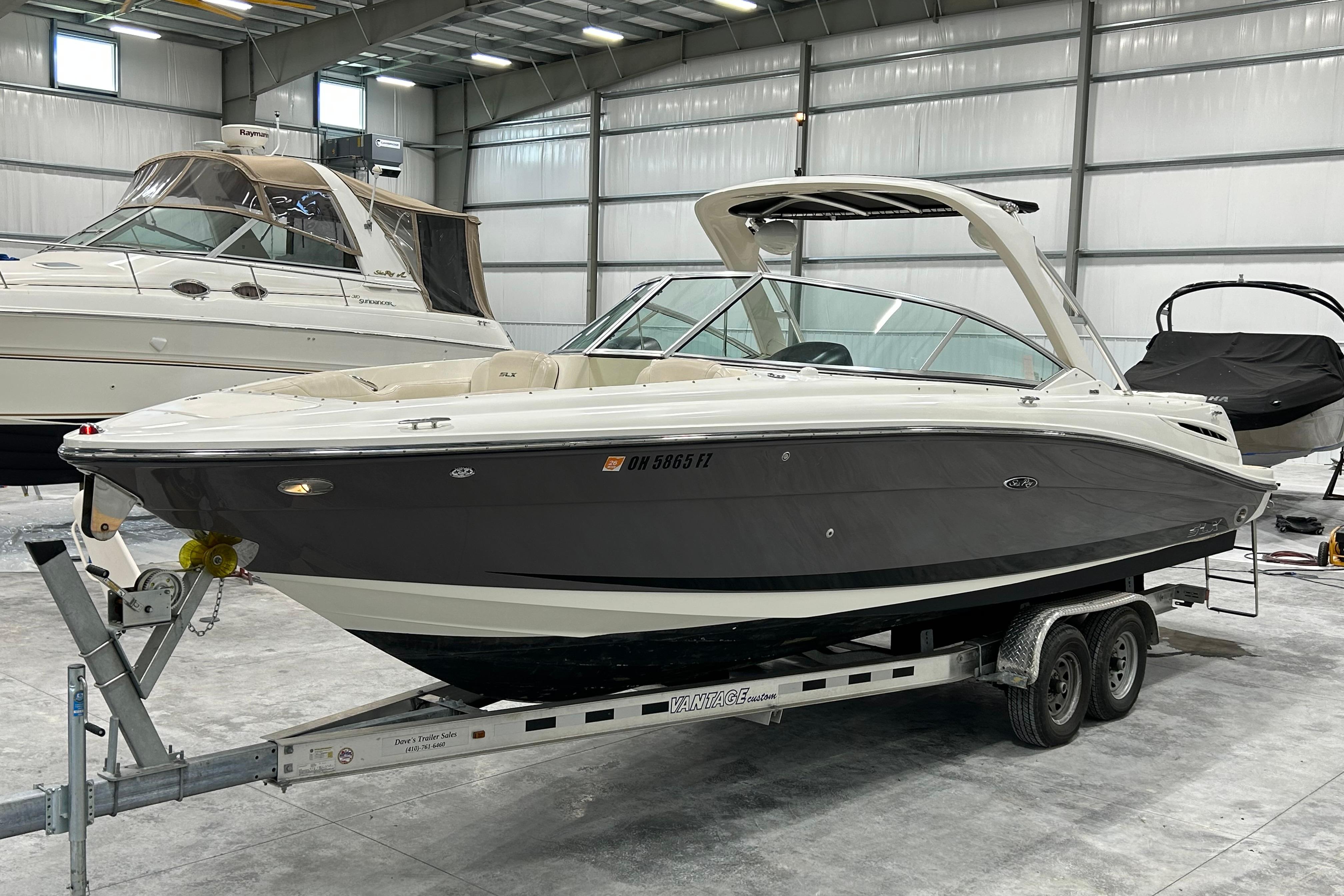 2006 Sea Ray 270 SLX boat on trailer in indoor storage facility.
