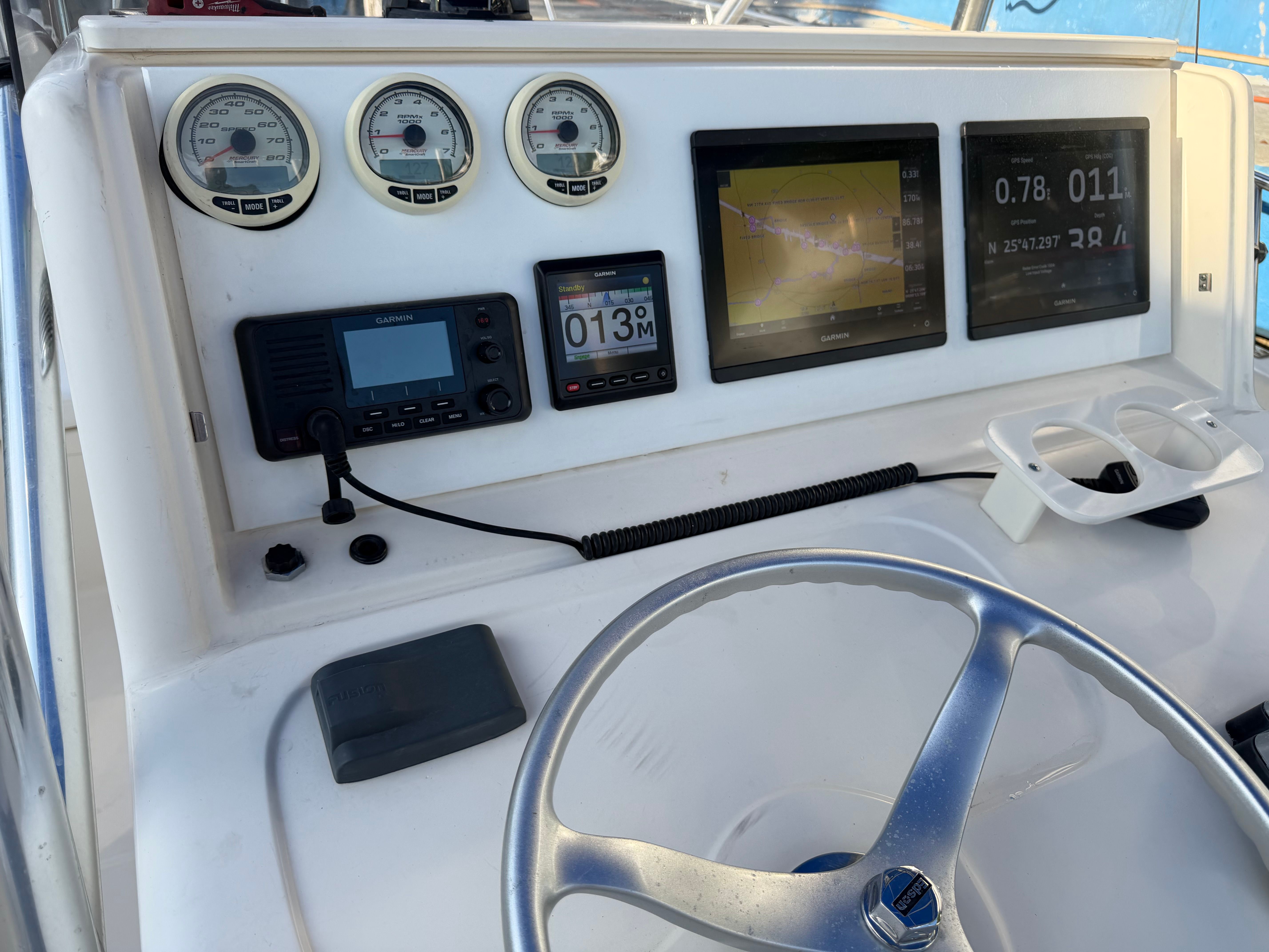 Helm console of a 2004 Pursuit 2870 boat with Garmin devices.