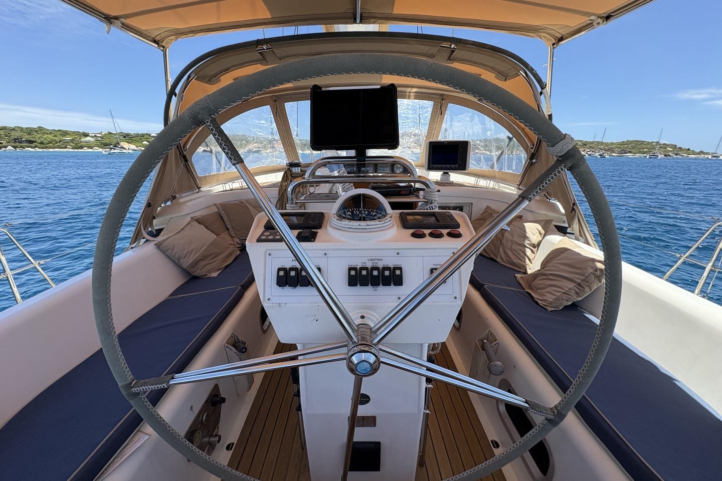Cockpit of a 2005 Oyster 56 yacht with steering wheel and navigation equipment.