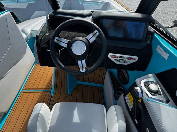 2022 Nautique S23 boat interior with modern steering wheel and dashboard.
