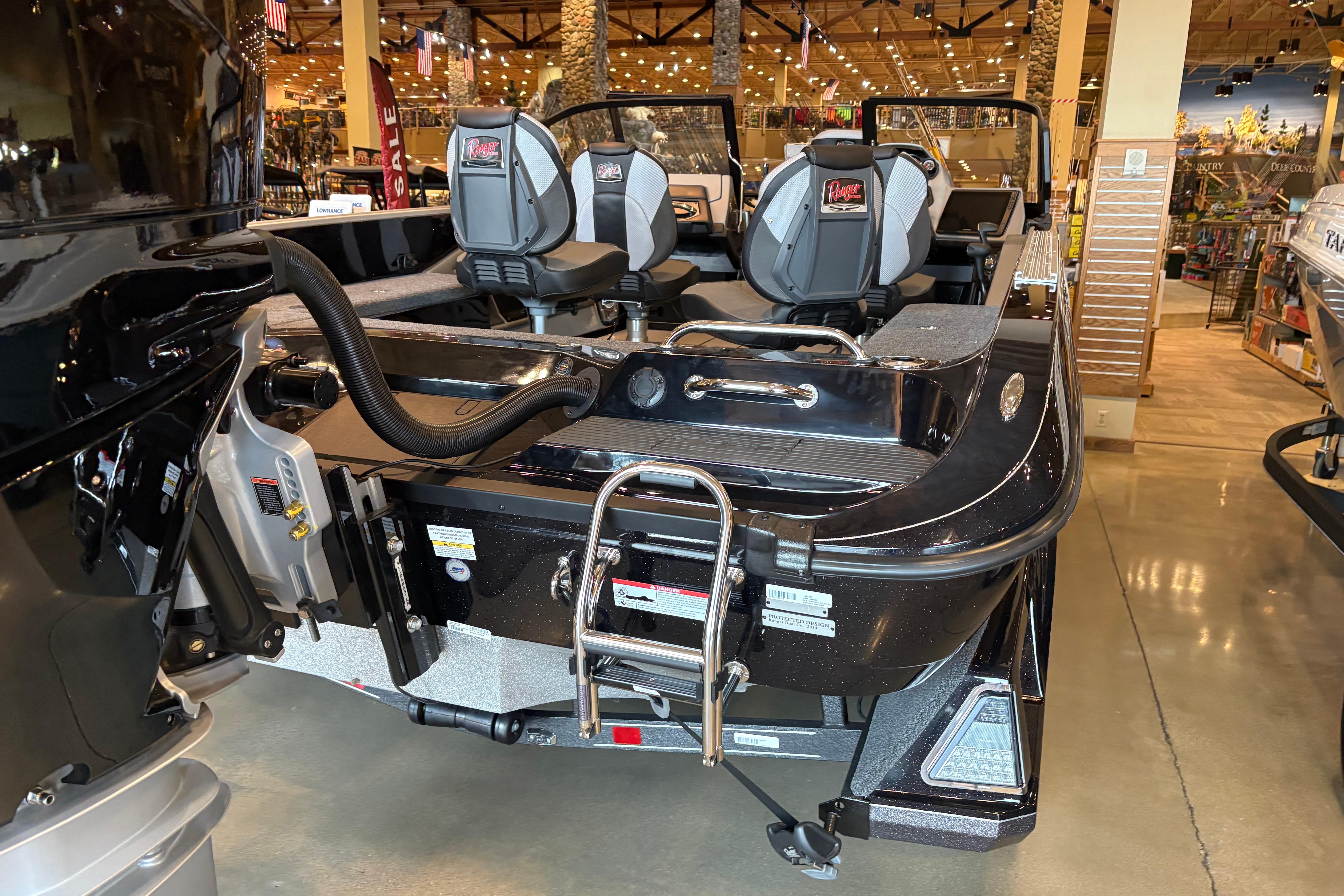 2026 Ranger 621FS Cup-Equipped boat displayed in showroom, featuring sleek design and modern seating.