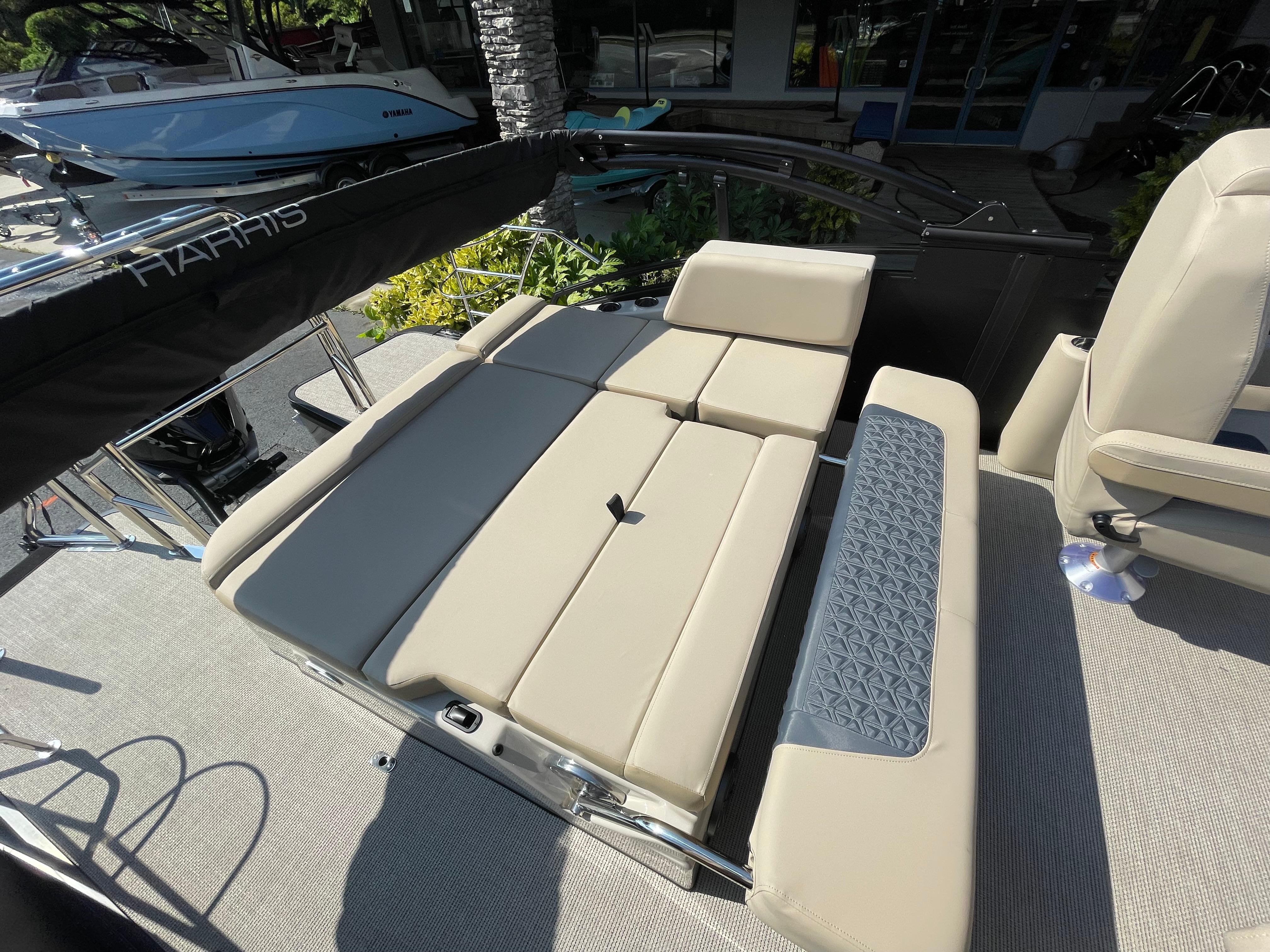 2026 Harris Solstice 230 boat interior with beige seating and modern design.