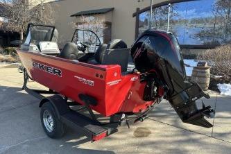 2026 Tracker Pro Guide V-175 Combo boat, red exterior, parked on a trailer outdoors.