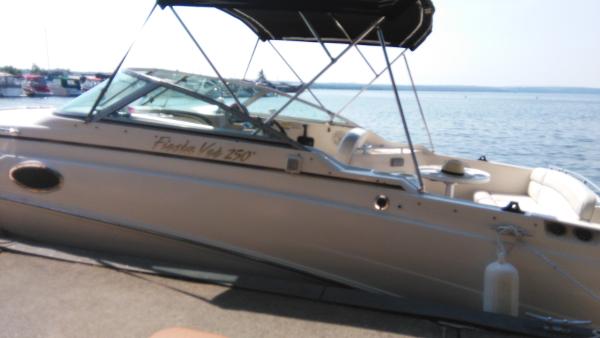 2004 Rinker Fiesta Vee 250 boat by the water.