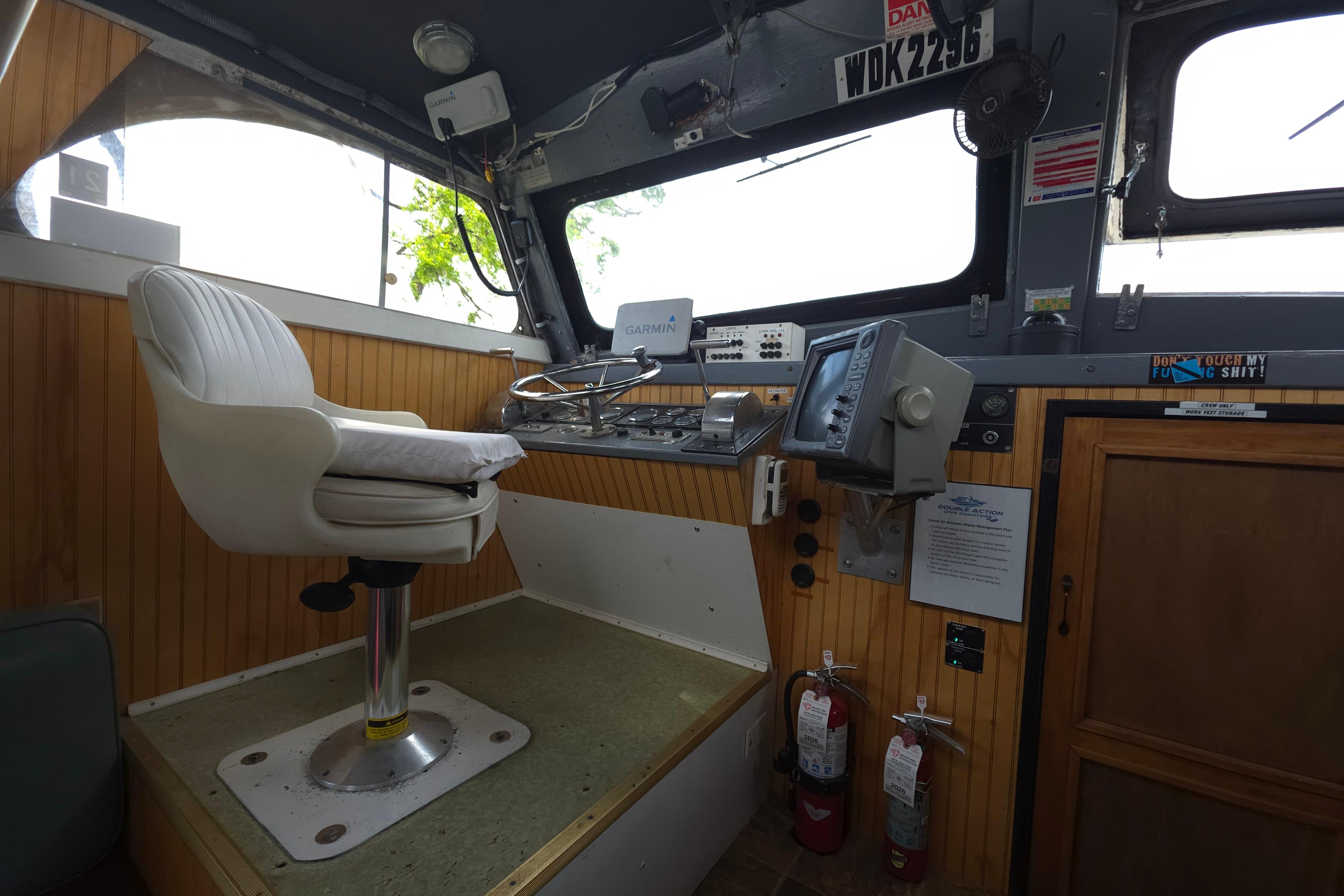 Interior of a 1974 Breaux's Bay Craft passenger boat cockpit with navigation equipment.