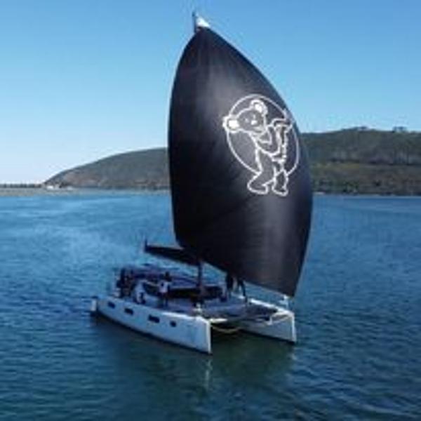 Sailing catamaran Vision 444 (2026) with a unique bear design on the sail.