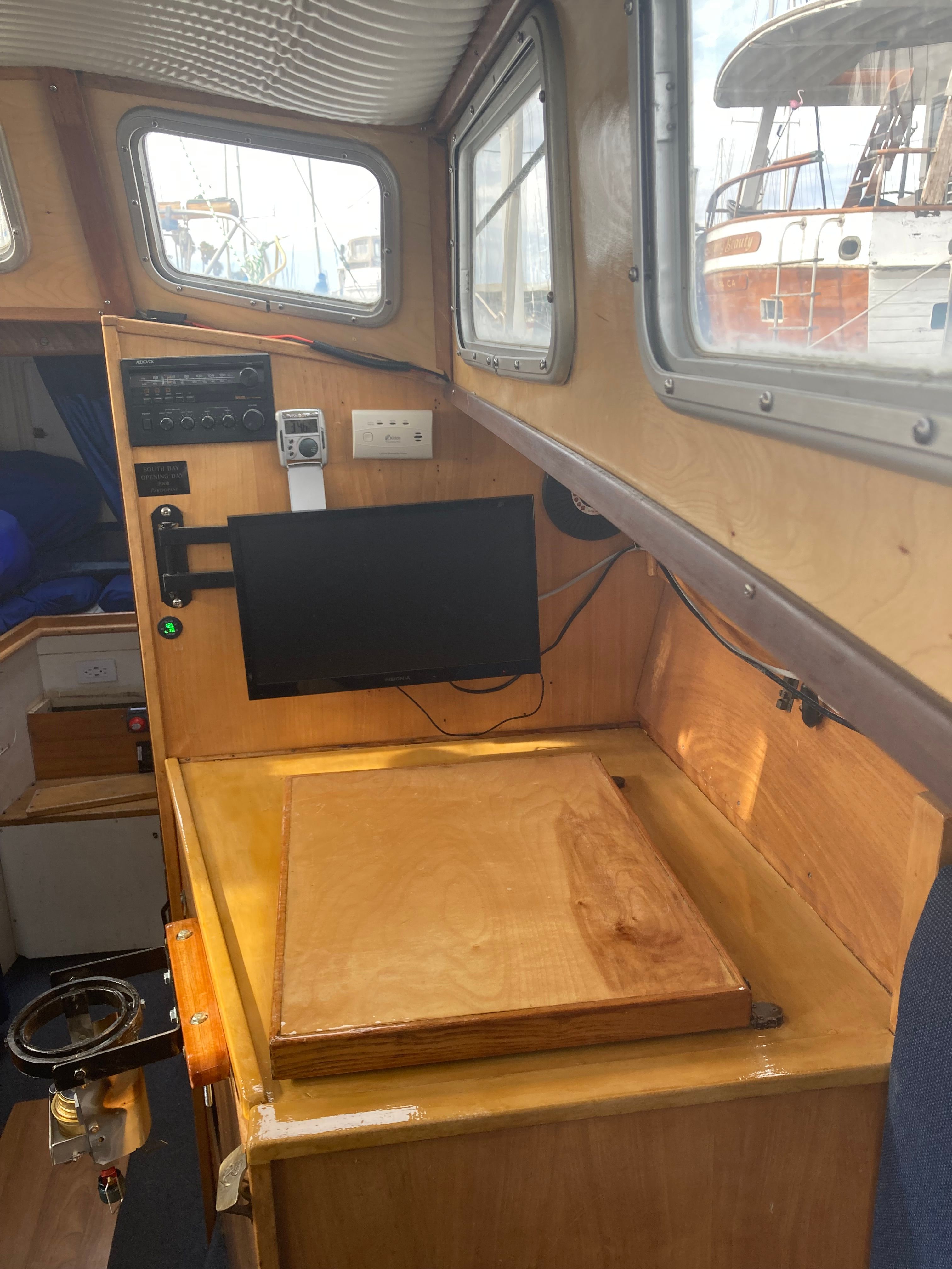 Interior of a 1969 Alberg Oceana with wood paneling and electronics.