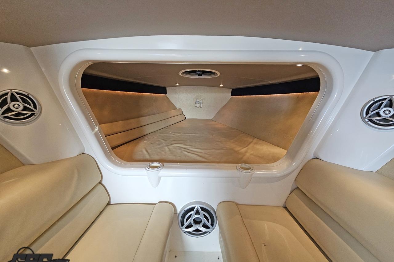 Interior of 2007 Hustler 41 Razor boat with beige seating and modern speakers.