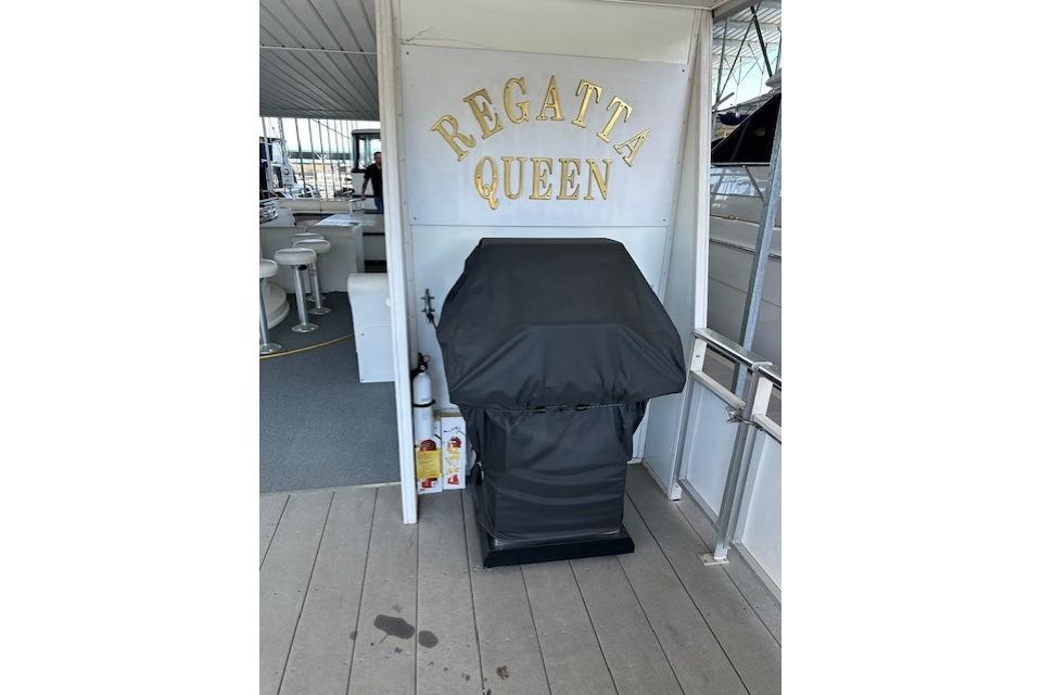Covered grill on 2008 Destination Yachts 45X14, labeled "Regatta Queen."