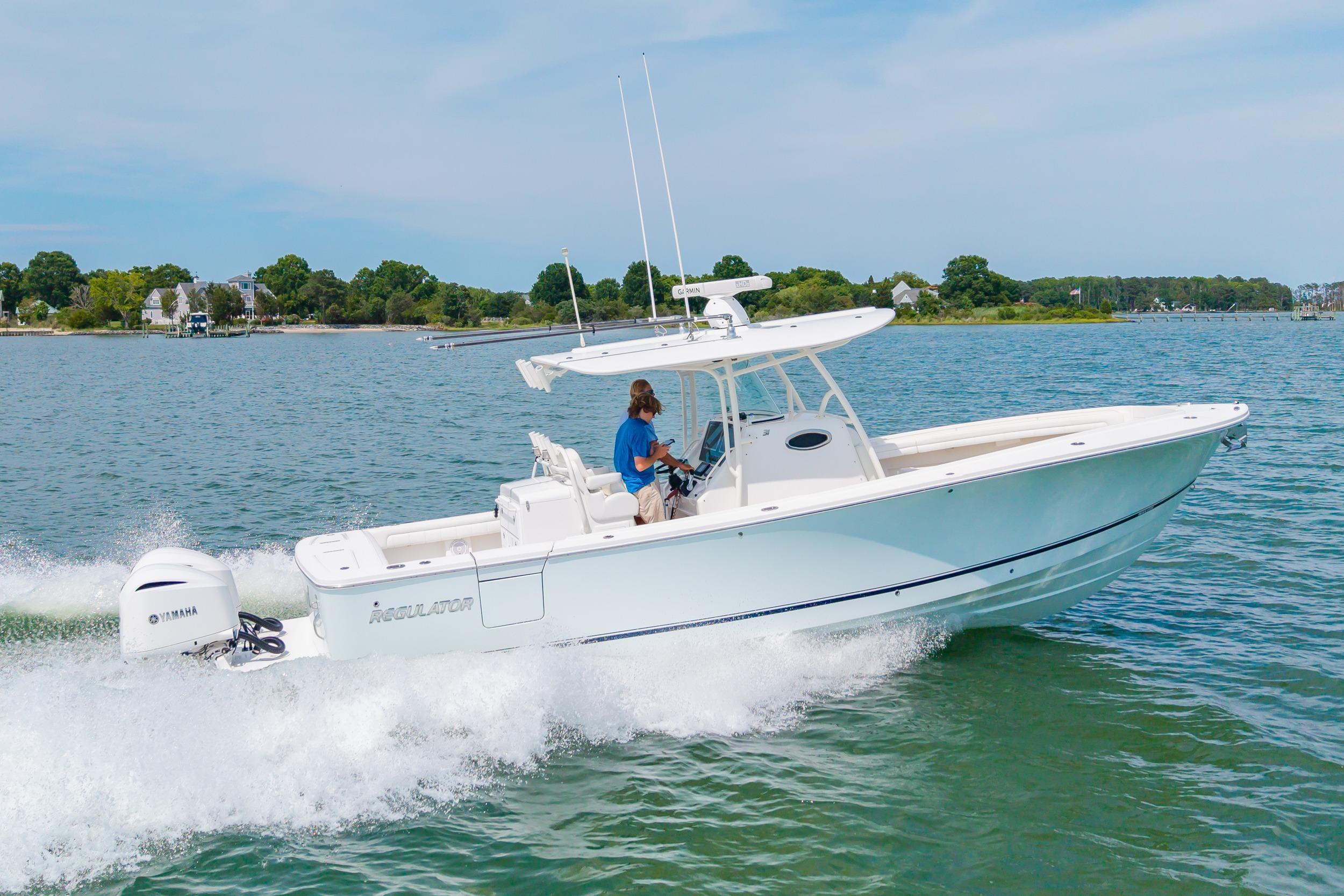 2019 Regulator 31 boat cruising on a sunny day with Yamaha engine.