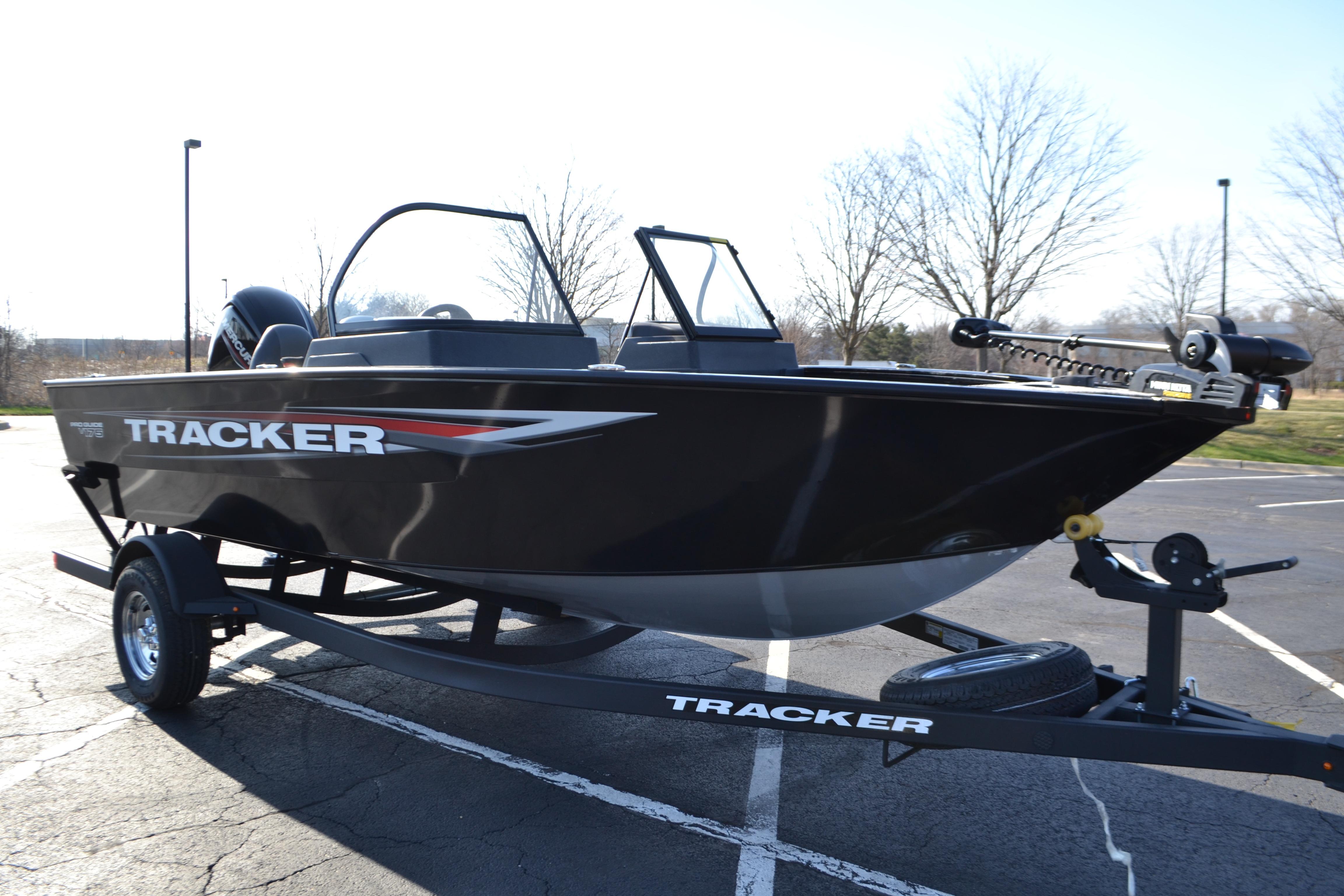 2026 Tracker Pro Guide V-175 WT boat on trailer in parking lot.