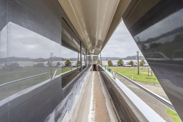 2025 Catamaran Bloomfield 86 Motorsailor deck view, showcasing sleek design and spacious walkway.