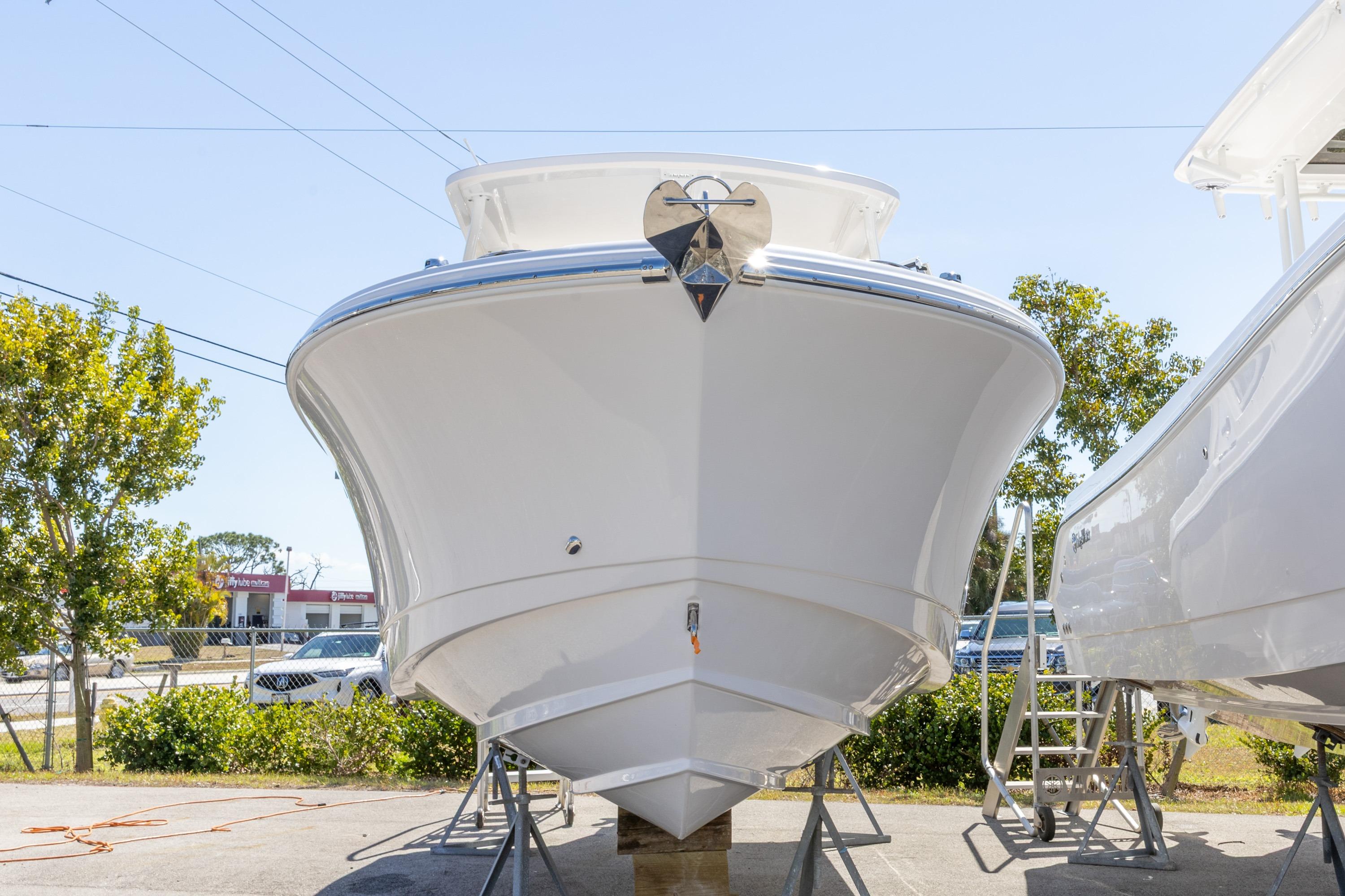 2026 Edgewater 248CX Crossover boat on display, front view, outdoors.