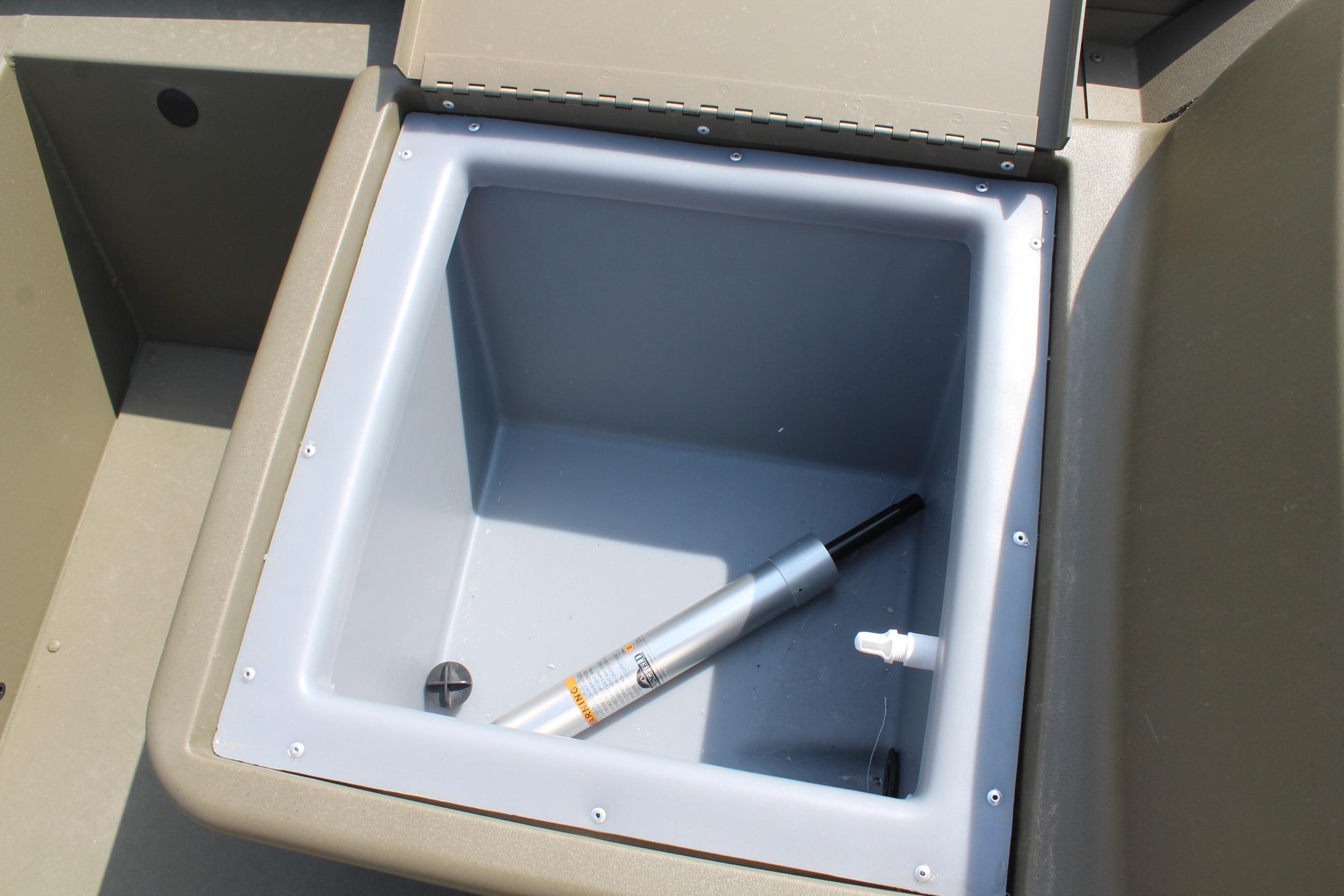 Open storage compartment in 2026 Tracker Grizzly 1754 SC boat, featuring a hydraulic strut.