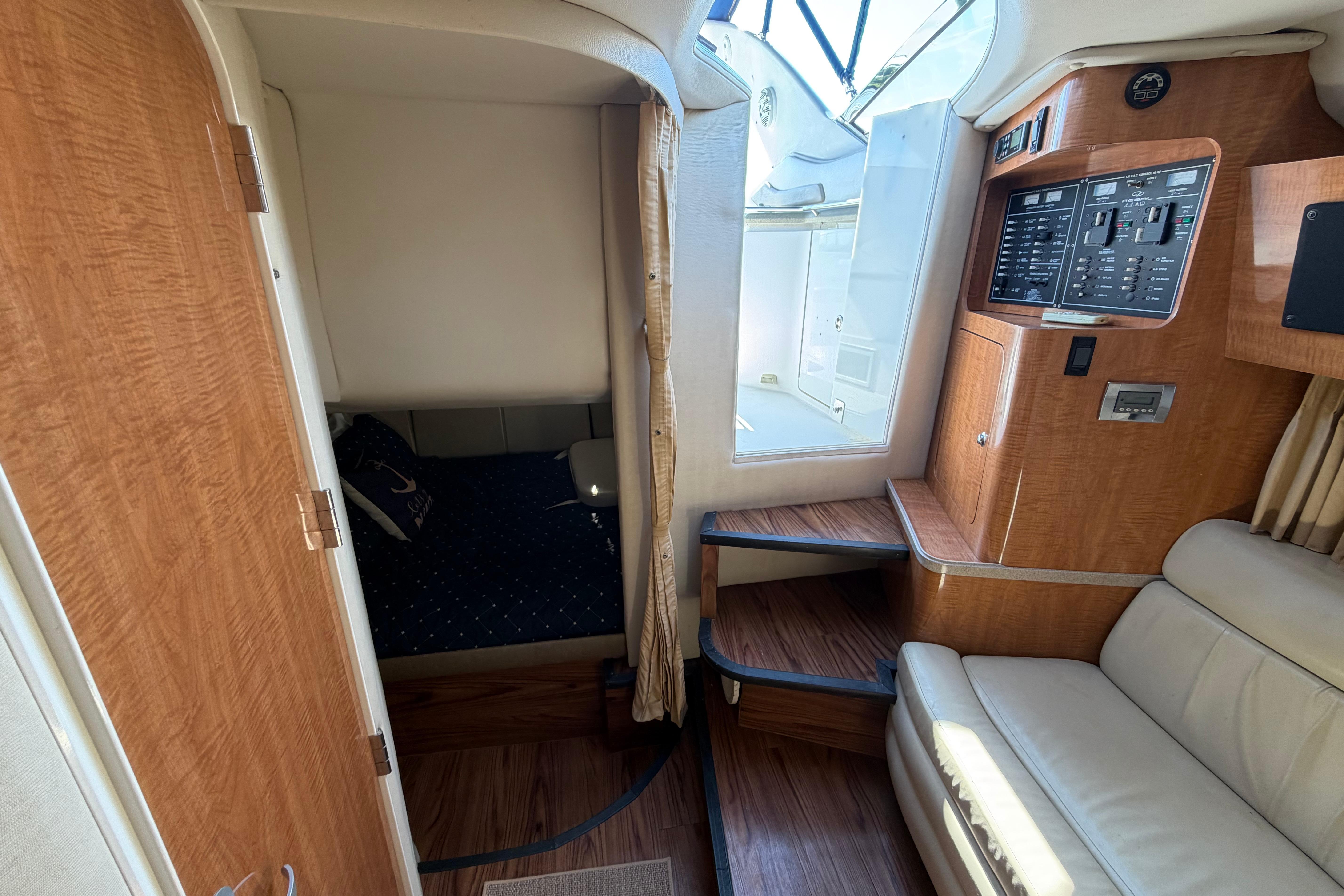 Interior of 2003 Regal Commodore 3260 yacht with wood paneling and seating area.