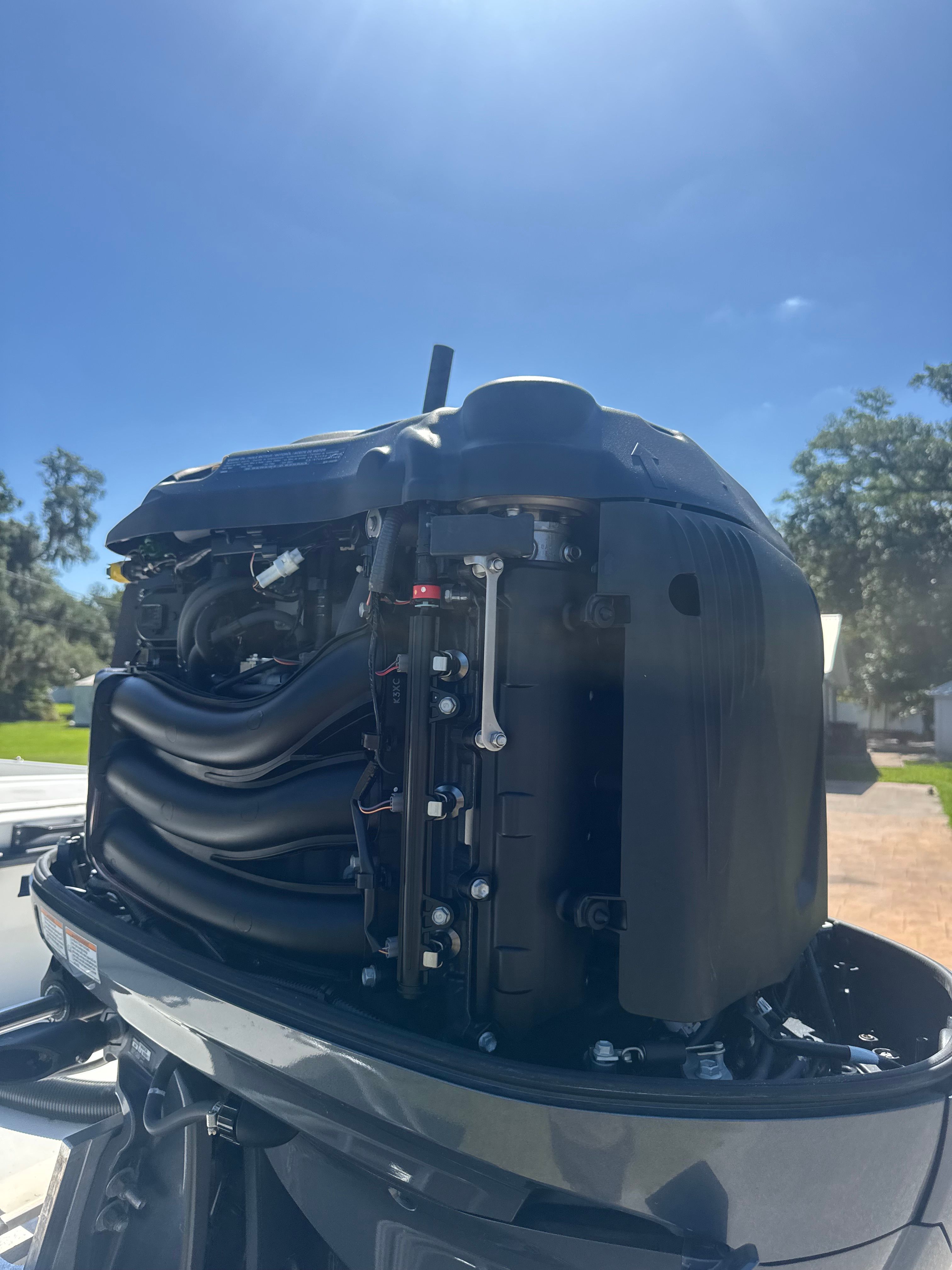 Open engine of a 1997 Parker 2520 boat under sunny skies.