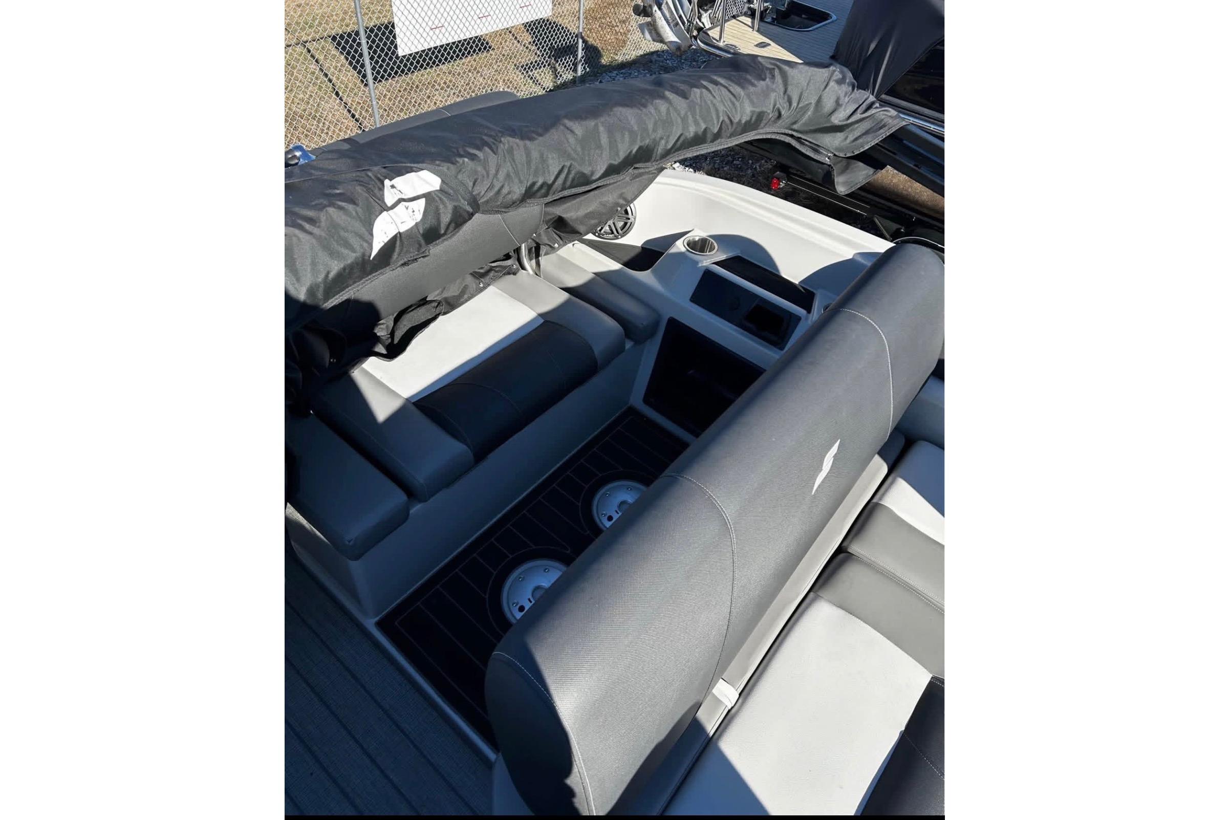2023 Starcraft MX 25 DL DH boat interior with seating and covered equipment.