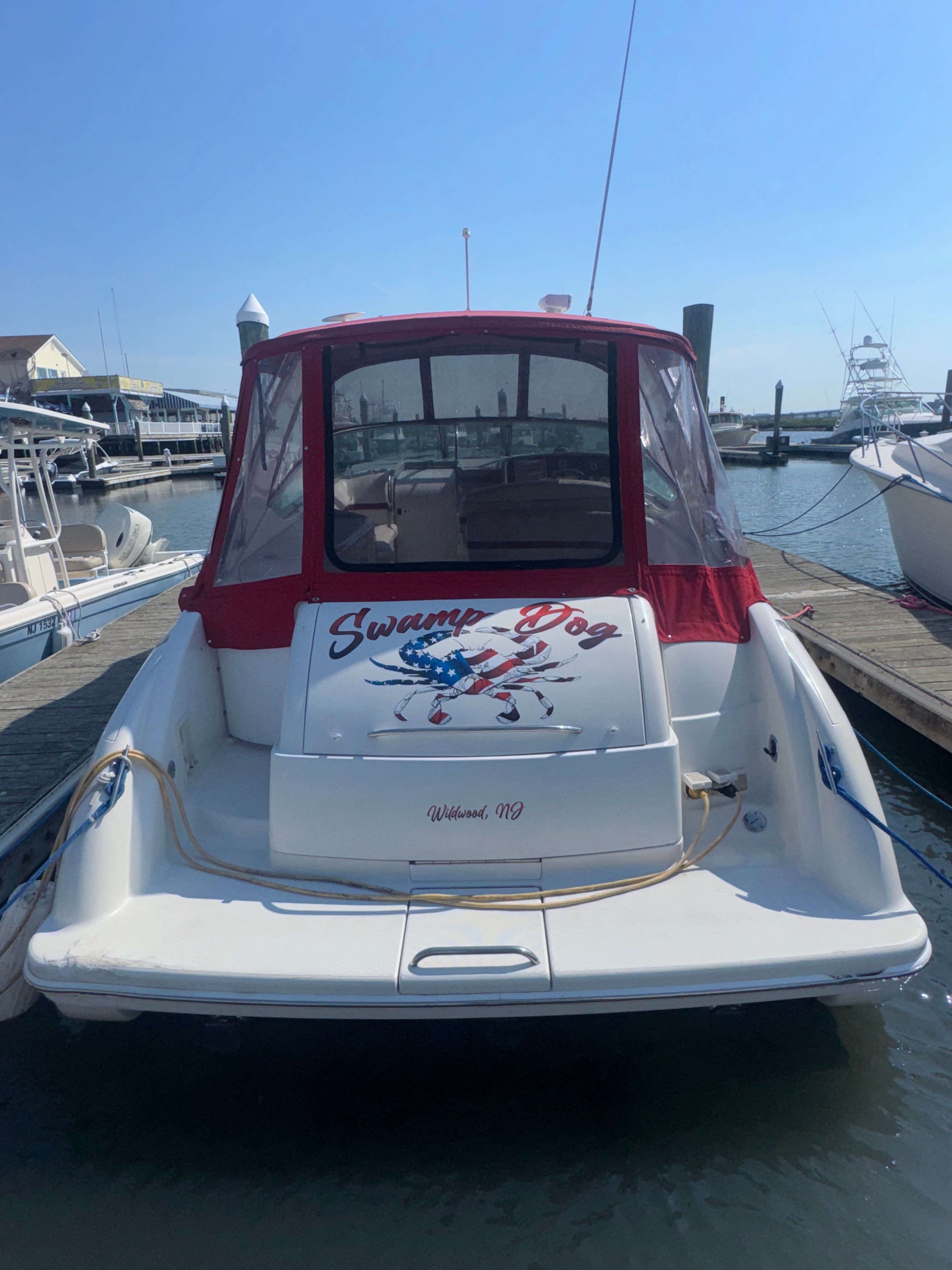 2001 Formula 37 Super Sport boat docked, featuring "Swamp Dog" design.