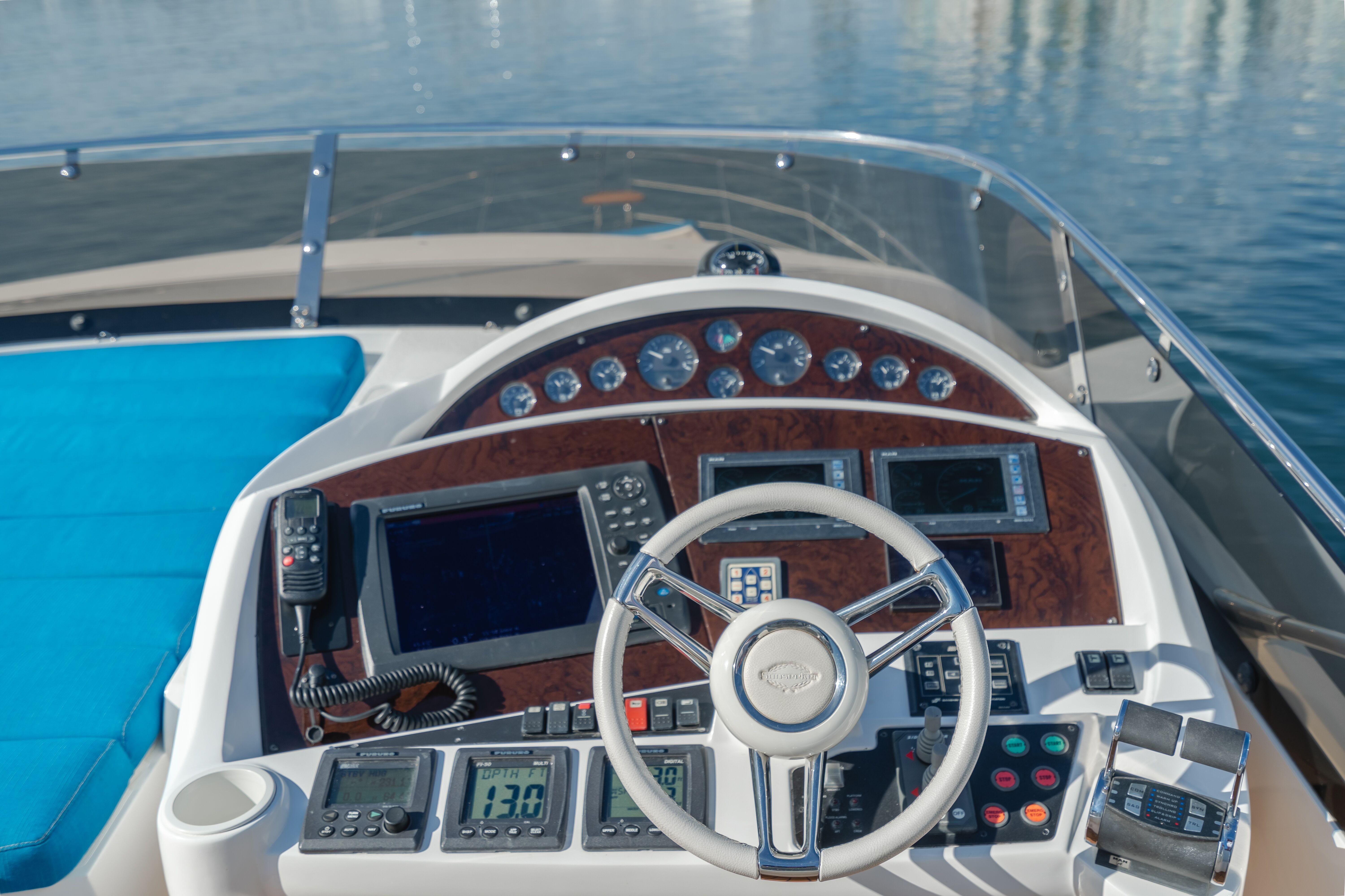 Cockpit of 2010 Sunseeker Manhattan 60 yacht with modern navigation equipment and steering wheel.