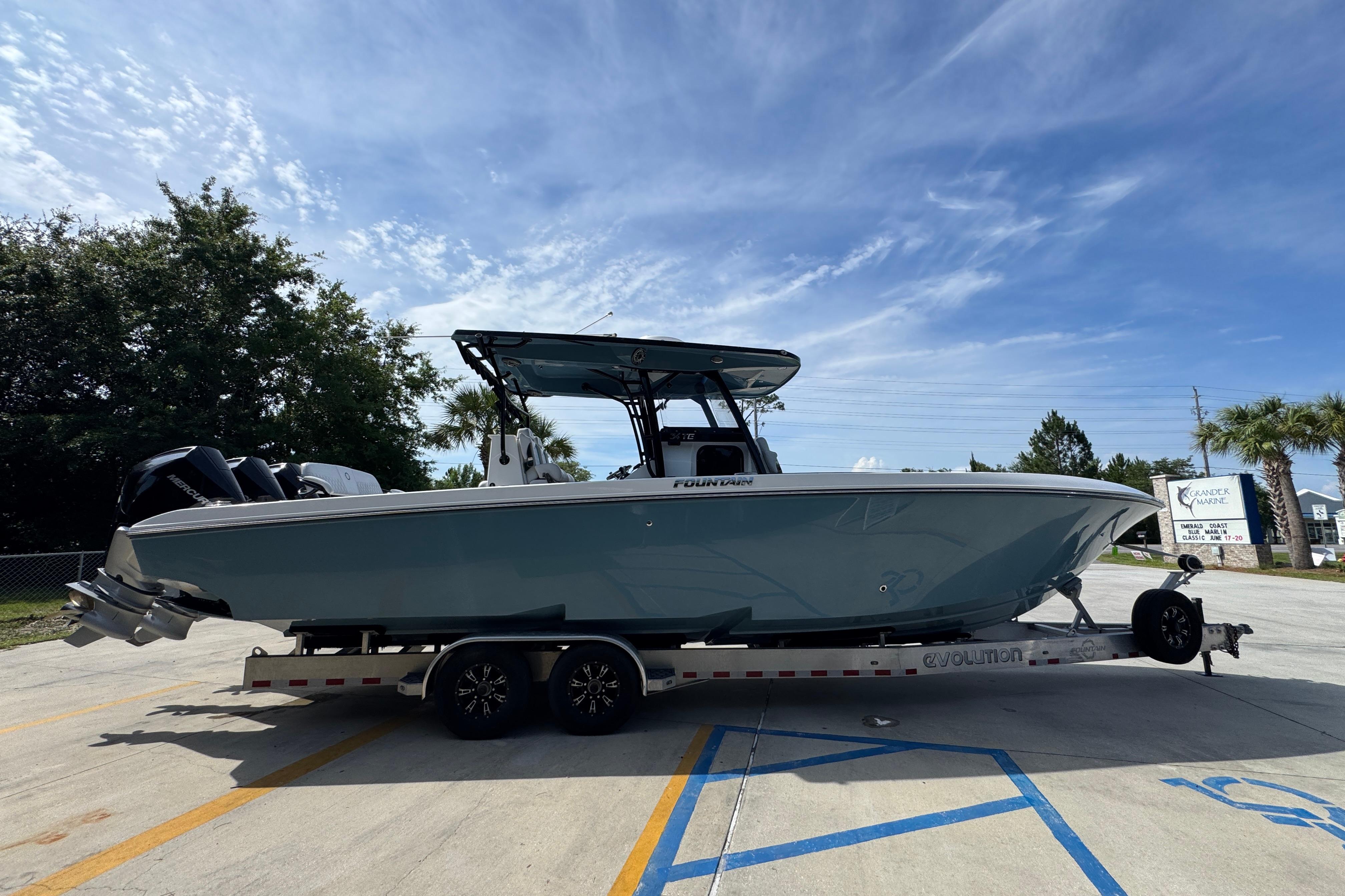 2023 Fountain 34 Tournament Edition boat on trailer under clear sky.