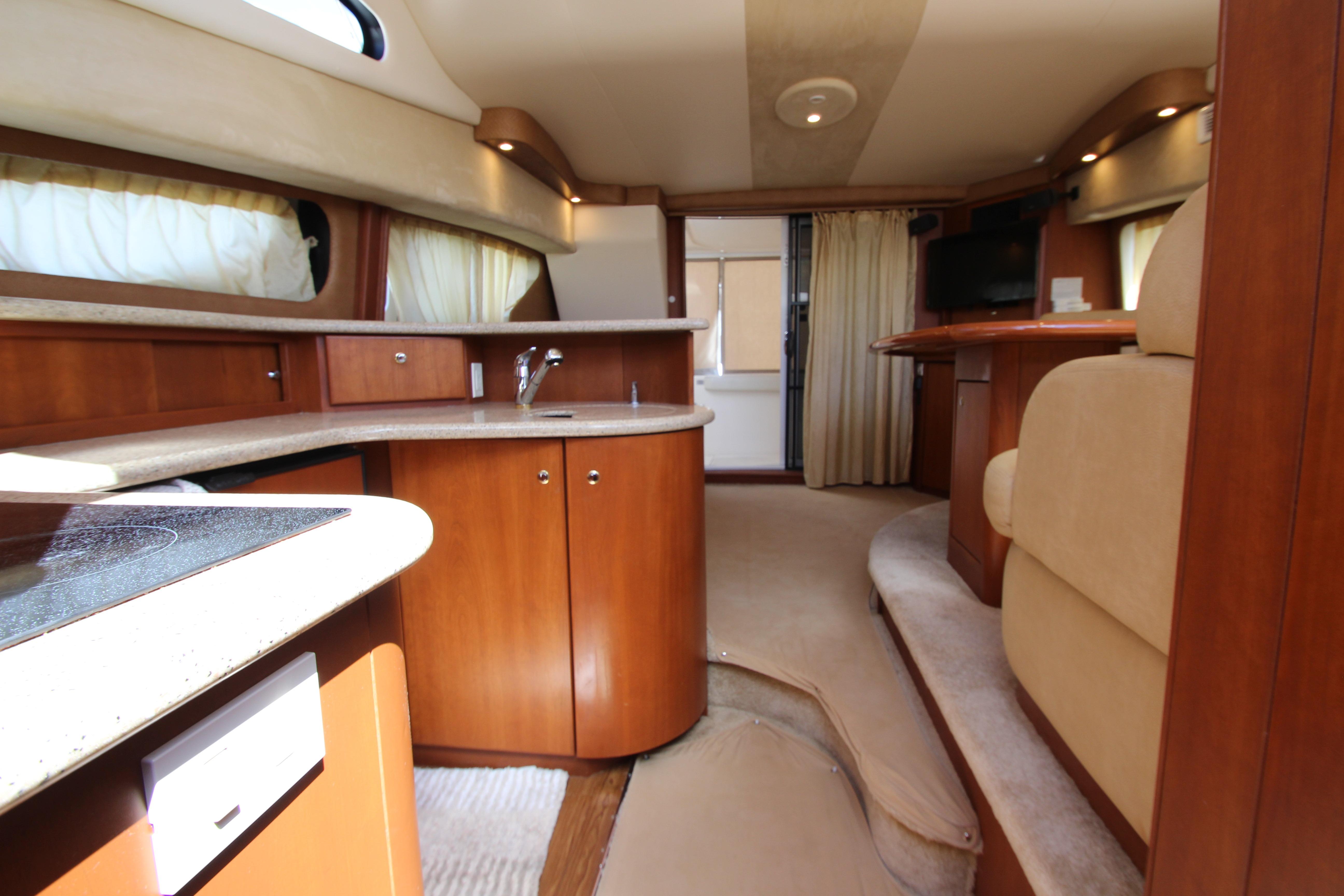 Interior of 2006 Silverton 38 Sport Bridge yacht with modern kitchen and seating area.