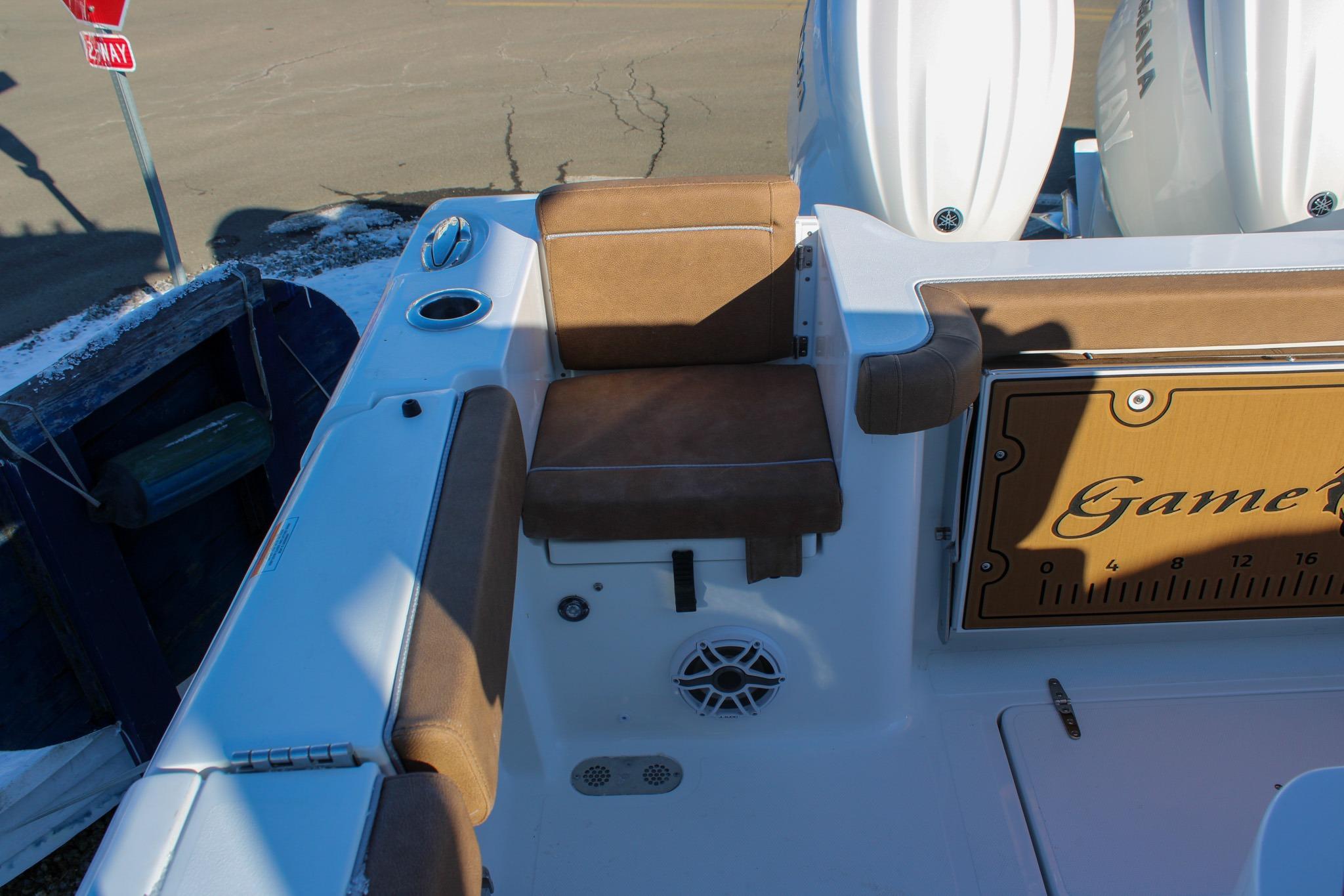 2026 Sea Hunt Gamefish 25 boat interior with brown seating and Yamaha engines.