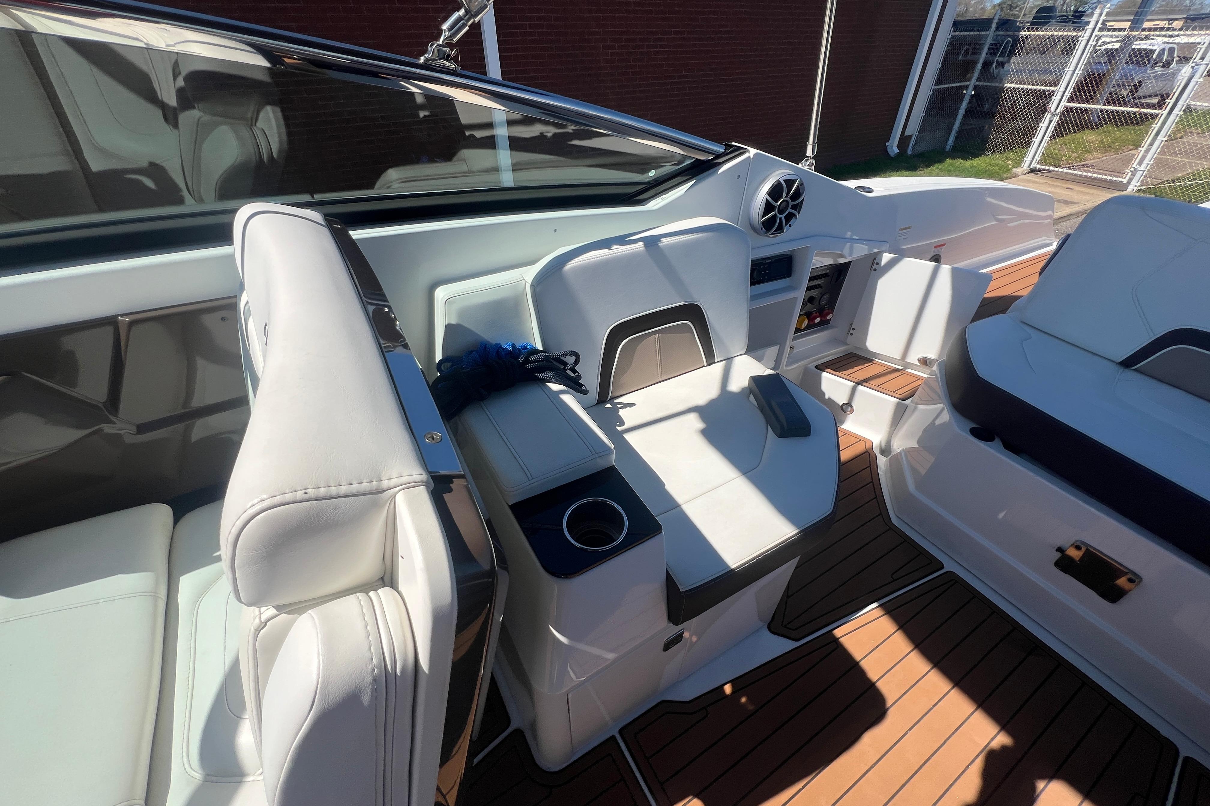 Interior of a 2017 Monterey 298SS Super Sport boat with white seating and wood flooring.
