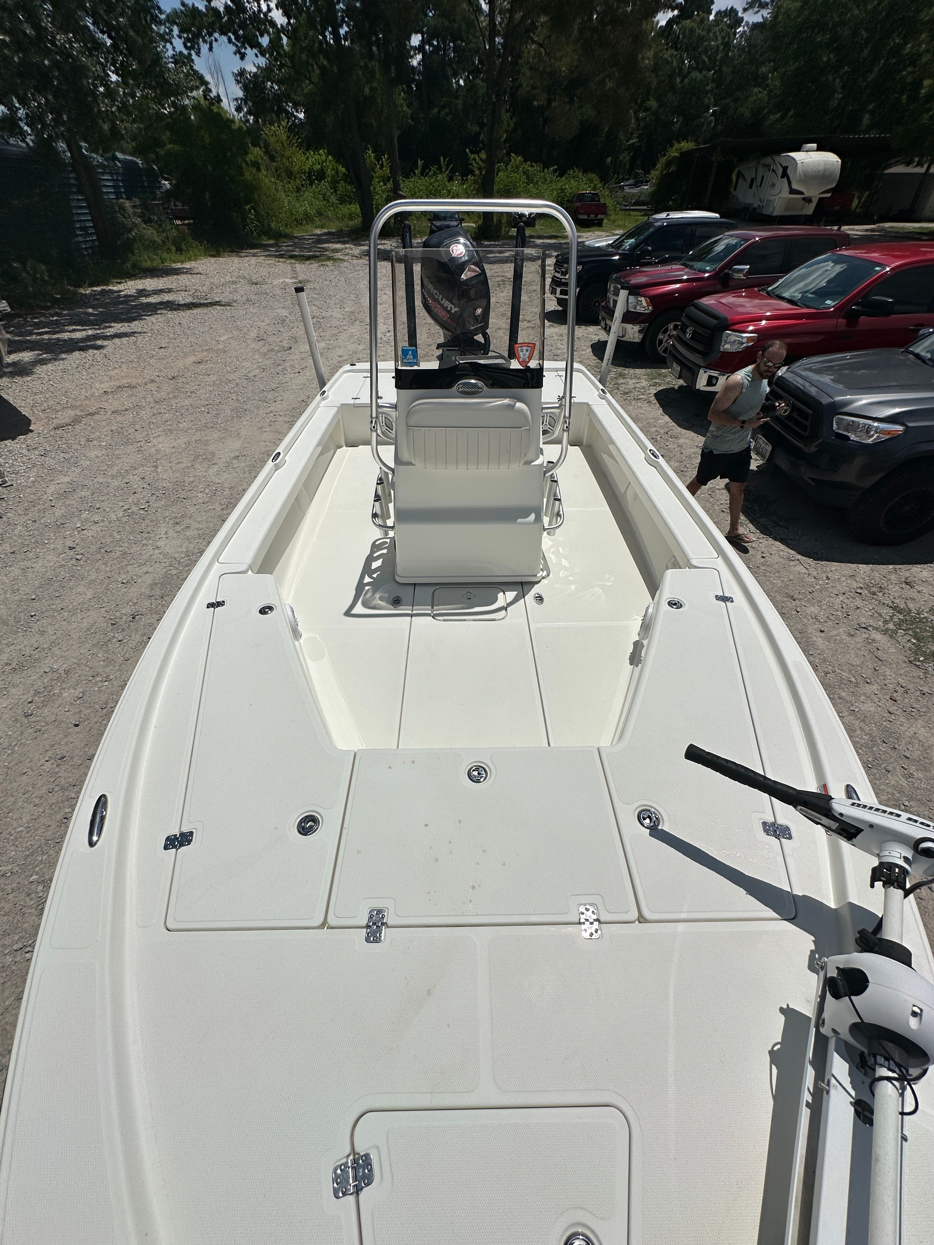 2014 Mako 21 LTS boat on a parking lot with cars.