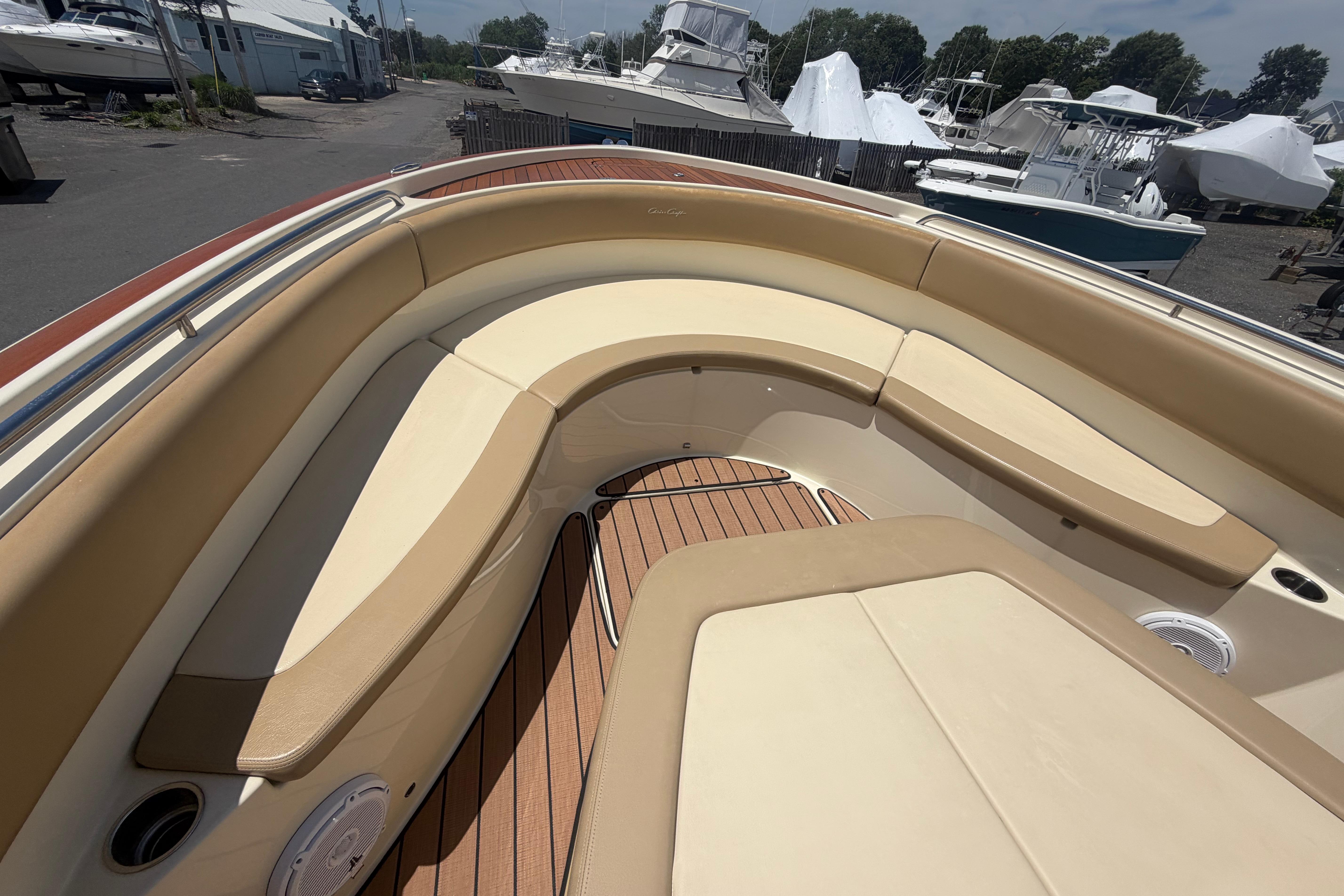 2017 Chris-Craft Catalina 34 boat interior with tan seating and wooden deck.