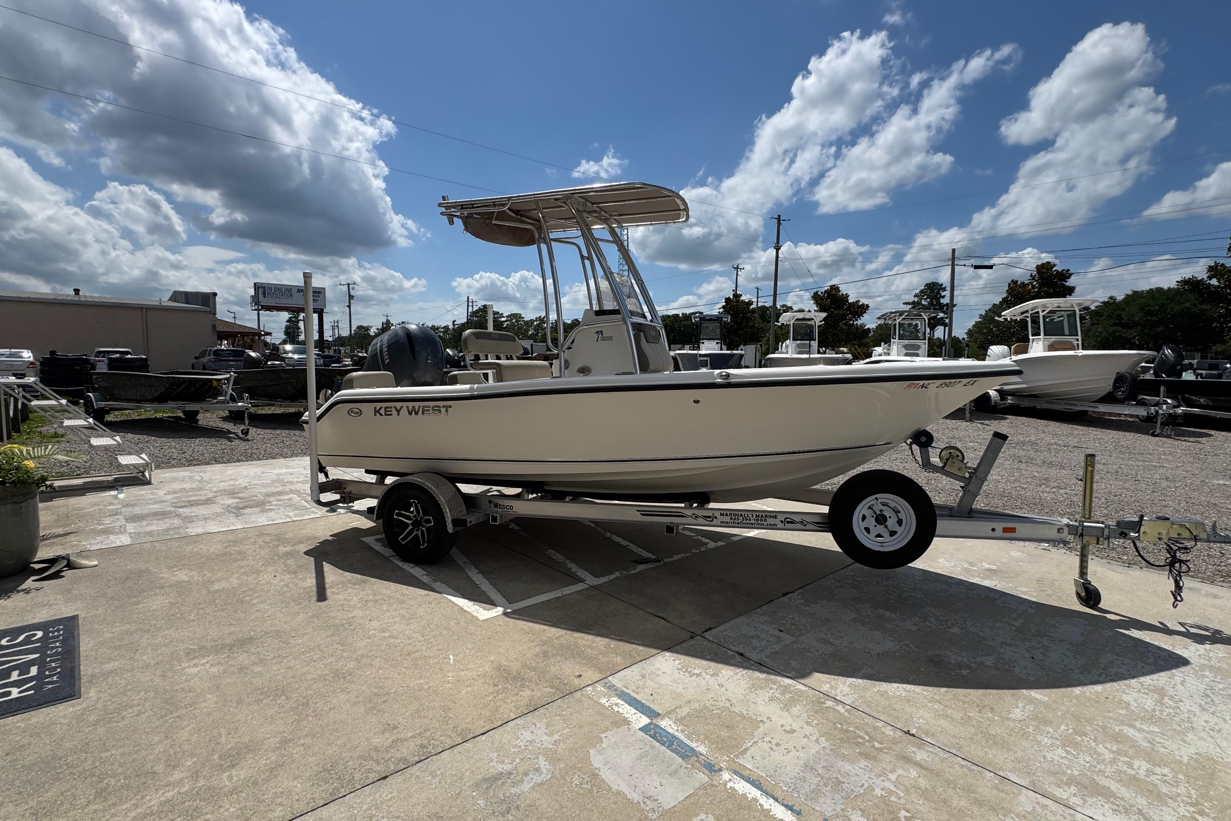 2022 Key West 189 FS boat on trailer under cloudy sky at dealership.