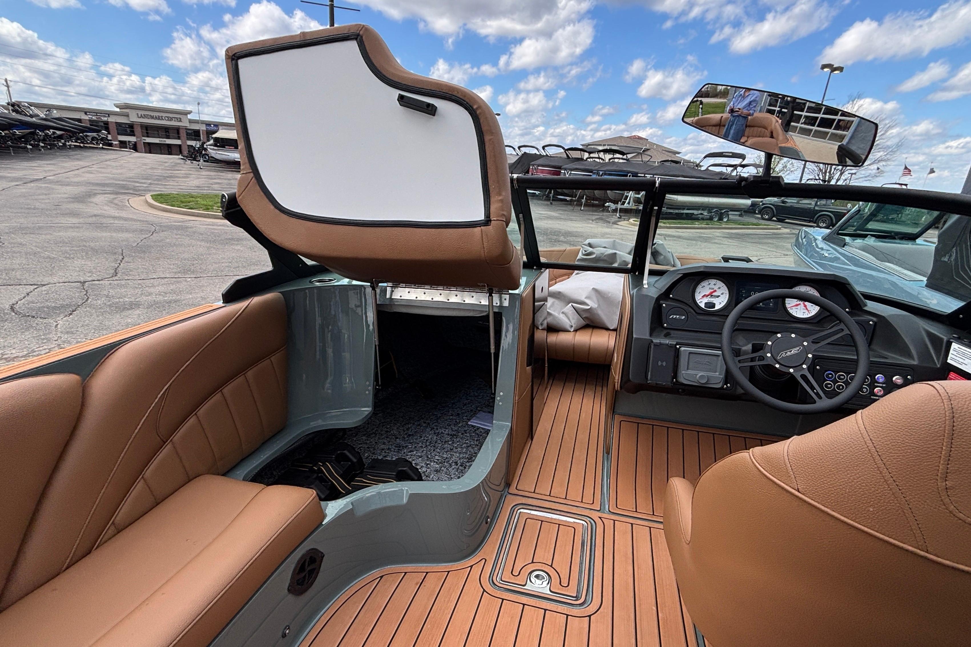 Interior of 2026 MB B52 23 Classic boat with tan seating and modern dashboard.