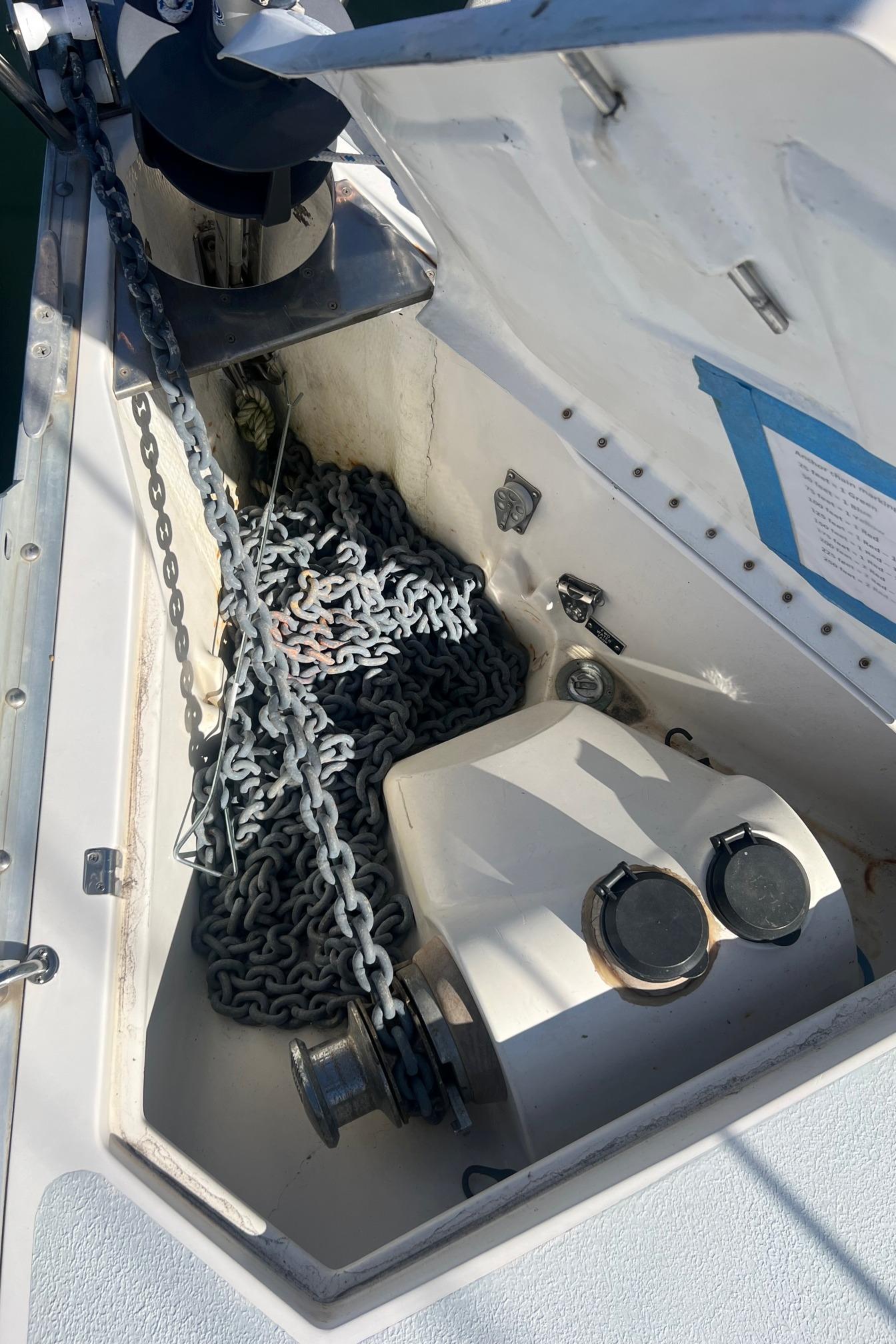 Anchor chain locker on a 1992 Hunter 43 sailboat, featuring winch and chain storage.