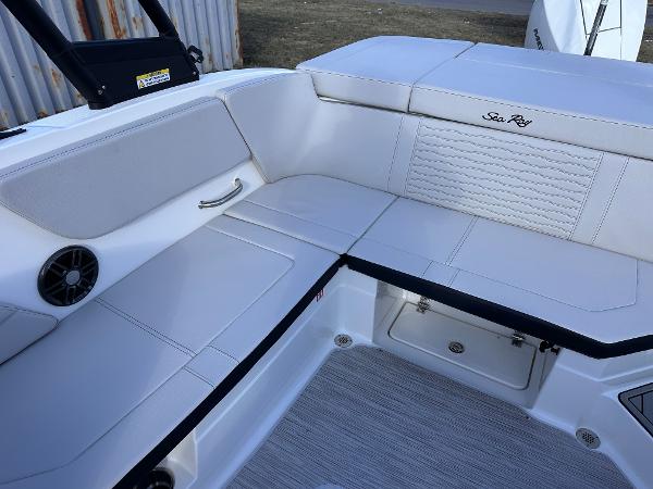 2025 Sea Ray SPX 230 OB boat interior with white seating and storage compartments.
