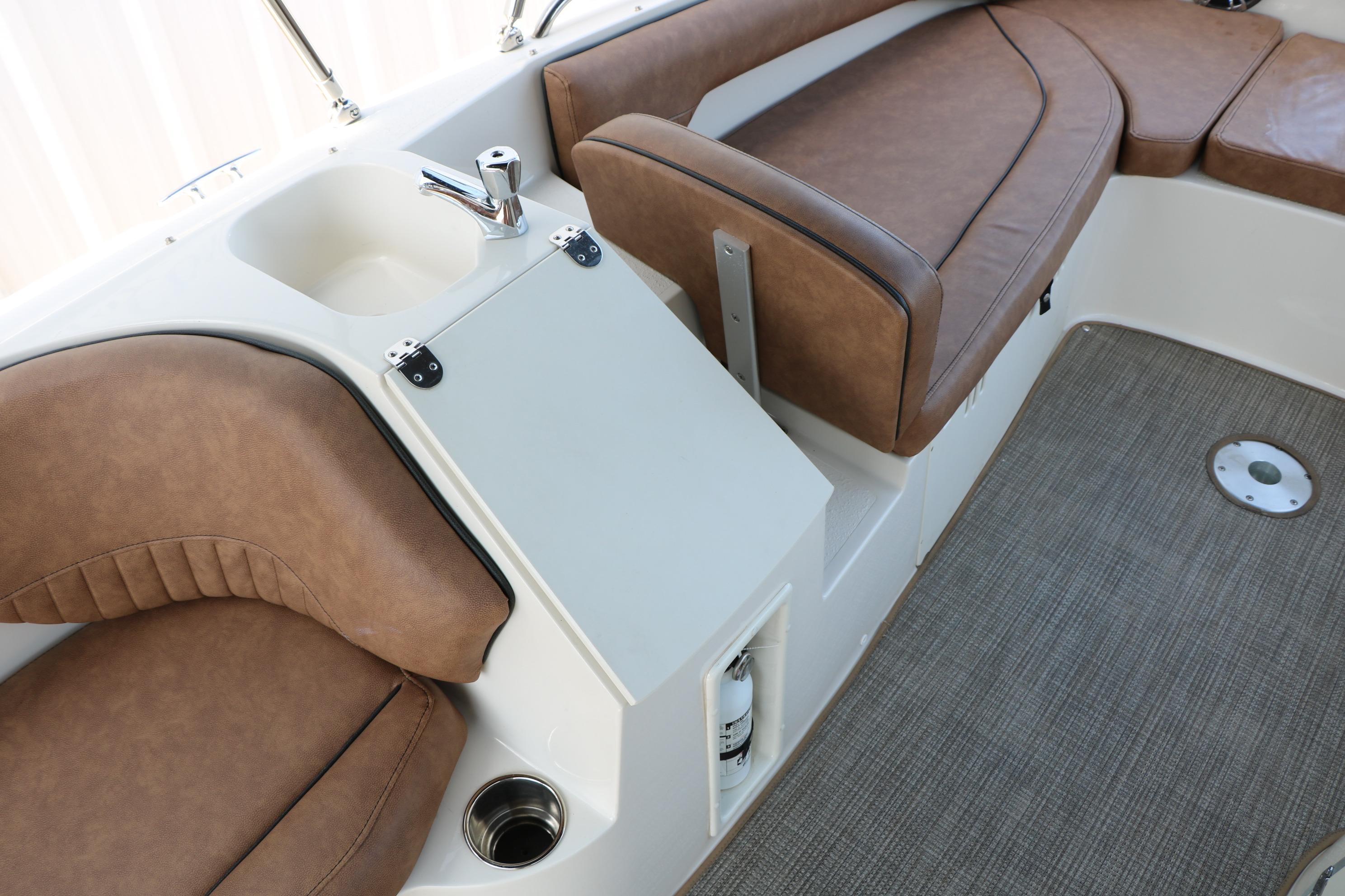 2022 Stingray 192 SC boat interior with brown seating and built-in sink.