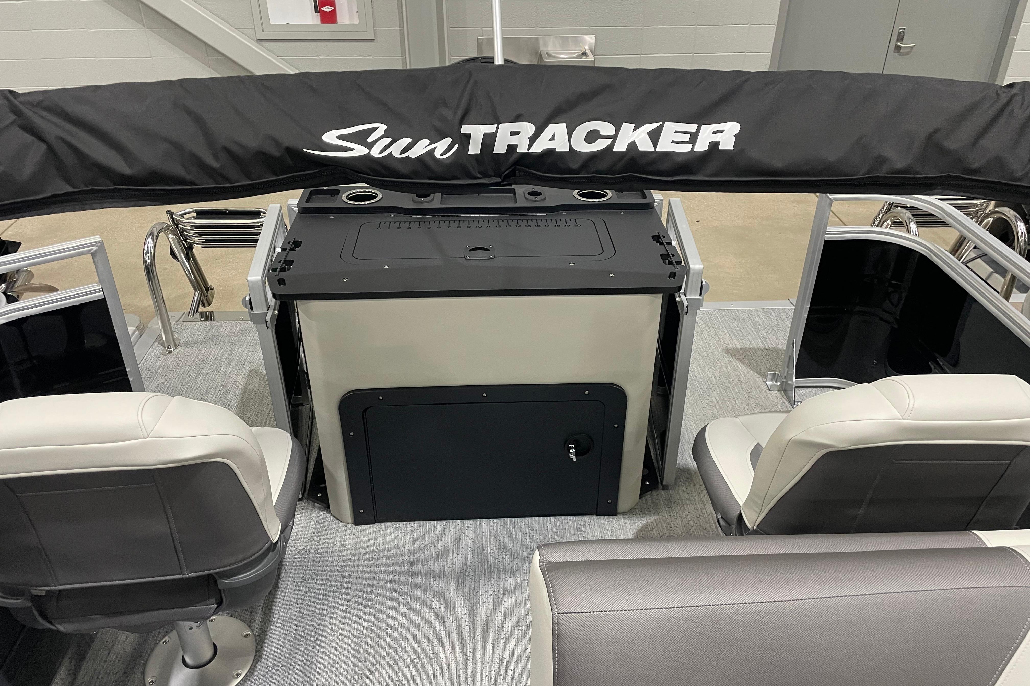 2026 Sun Tracker SportFish 22 DLX interior with seating and covered console.