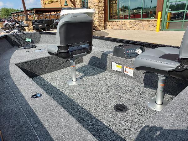 2025 Tracker Super Guide V-16 T boat interior with gray seating and carpeted flooring.