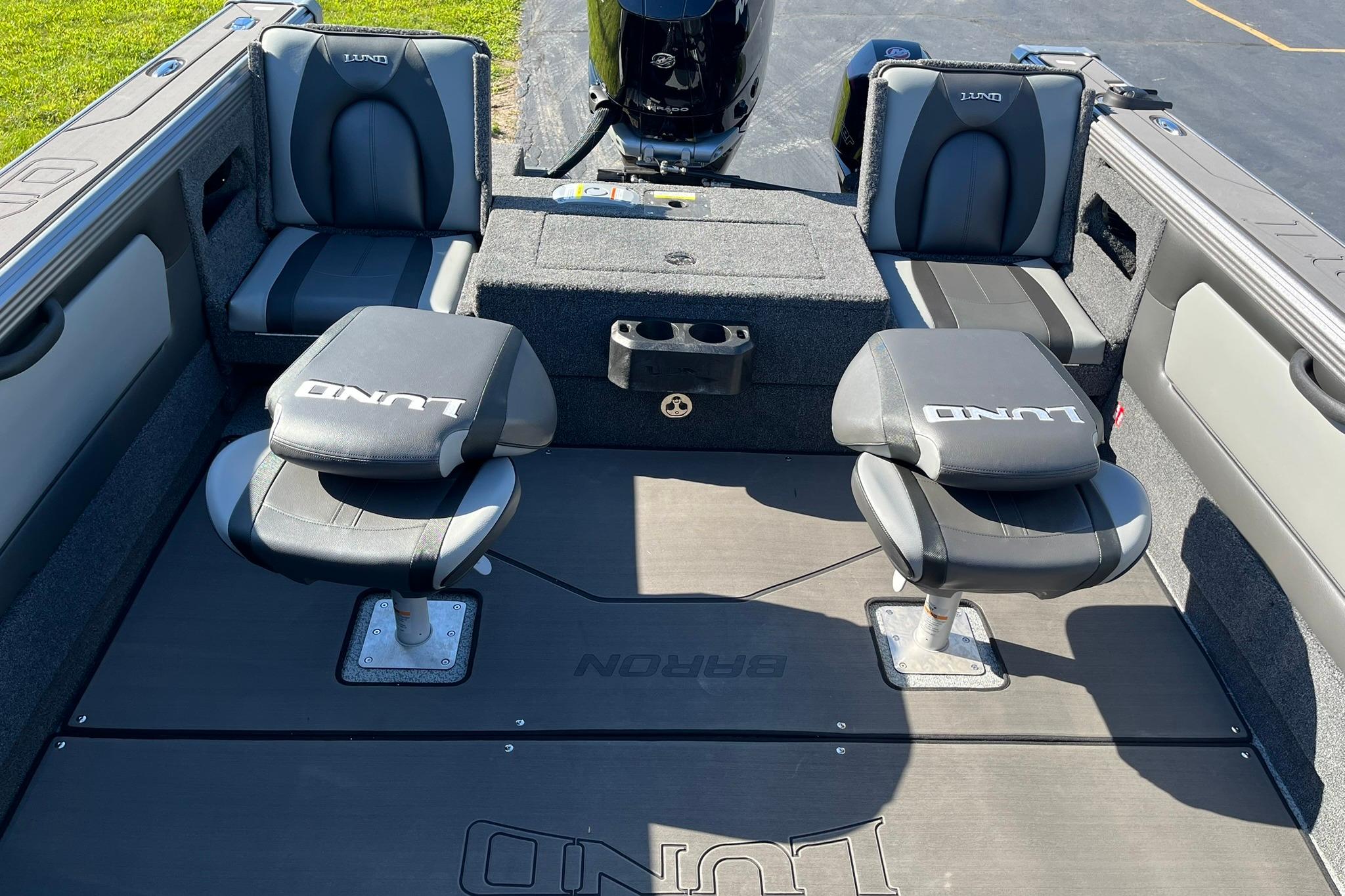 2026 Lund 2275 Baron boat interior with seating and storage compartments.
