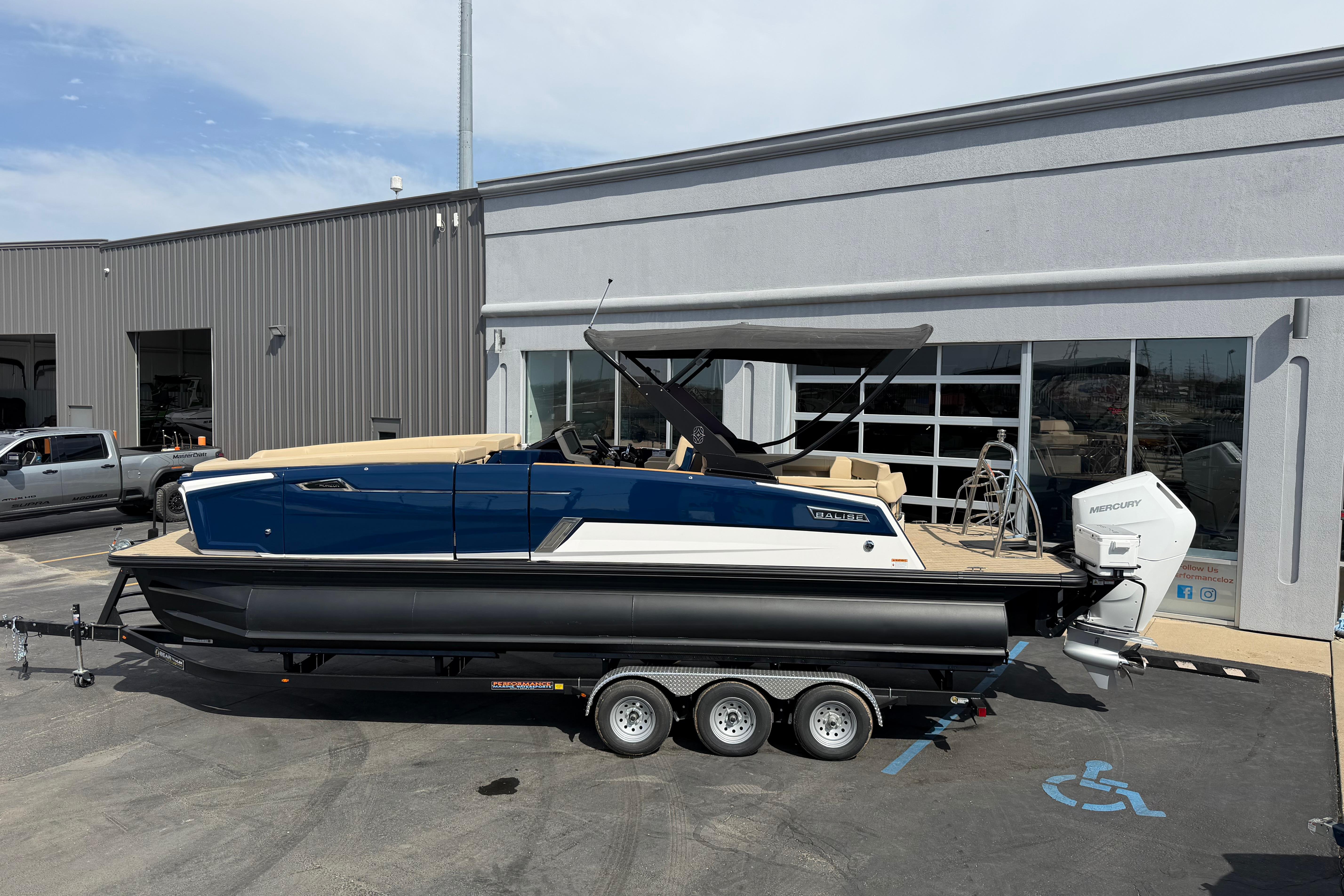 2025 Balise HORIZON26C boat on trailer outside a modern building.