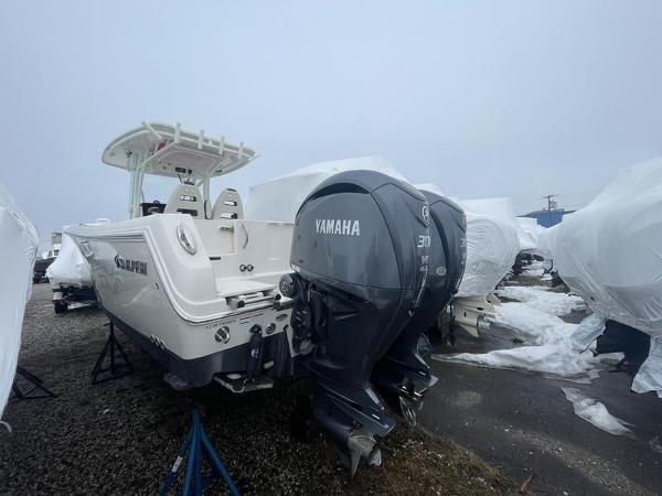 2023 Sailfish 290 CC boat with Yamaha engines in storage yard.