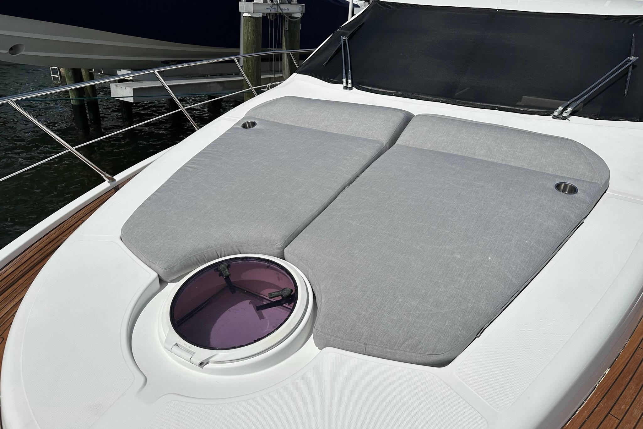 Sunbathing deck on 2013 Azimut Fly 53 yacht with cushioned seating and hatch.