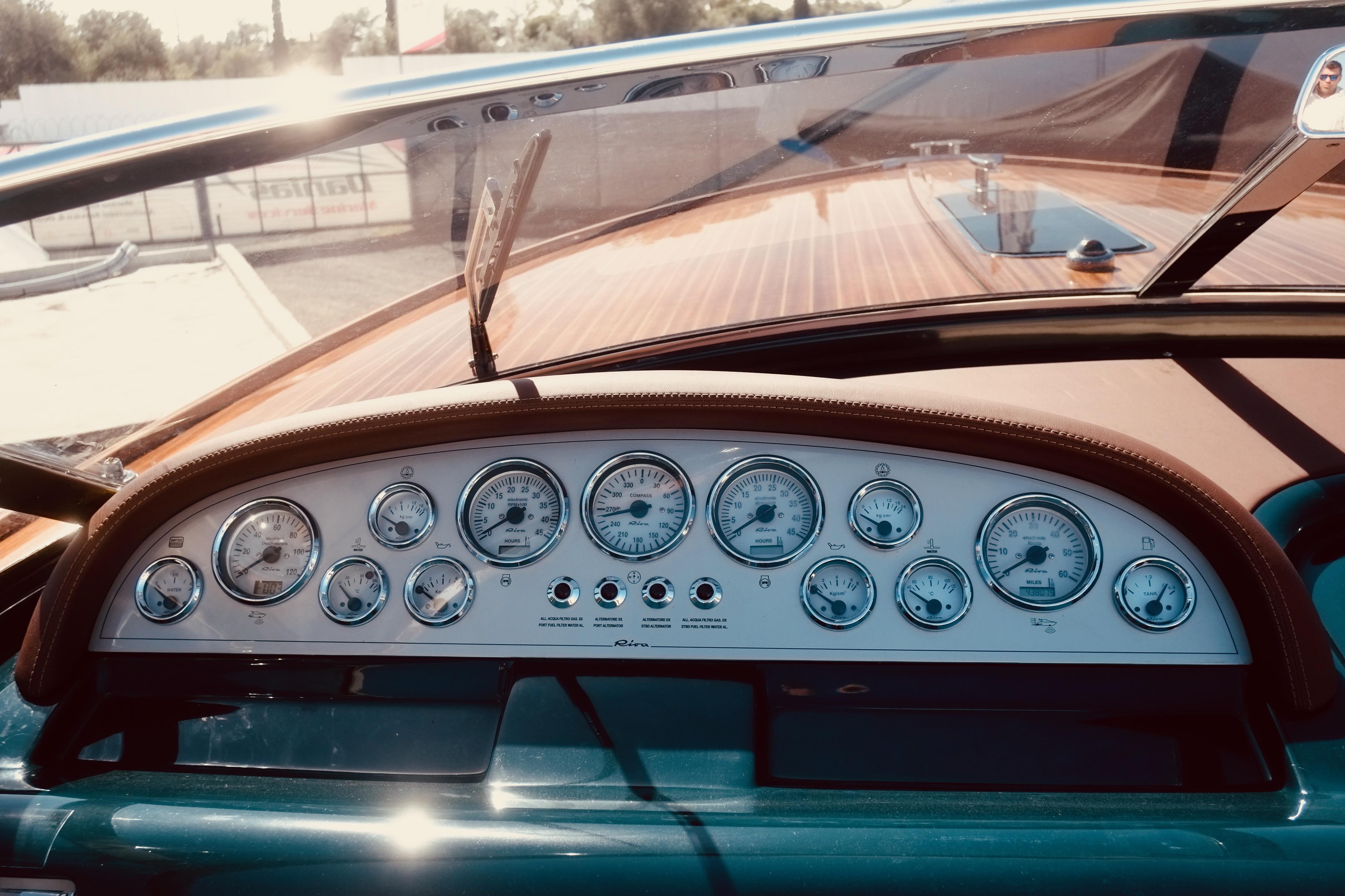 Dashboard of a 2003 Riva Aquariva 33 boat with vintage gauges and wooden accents.