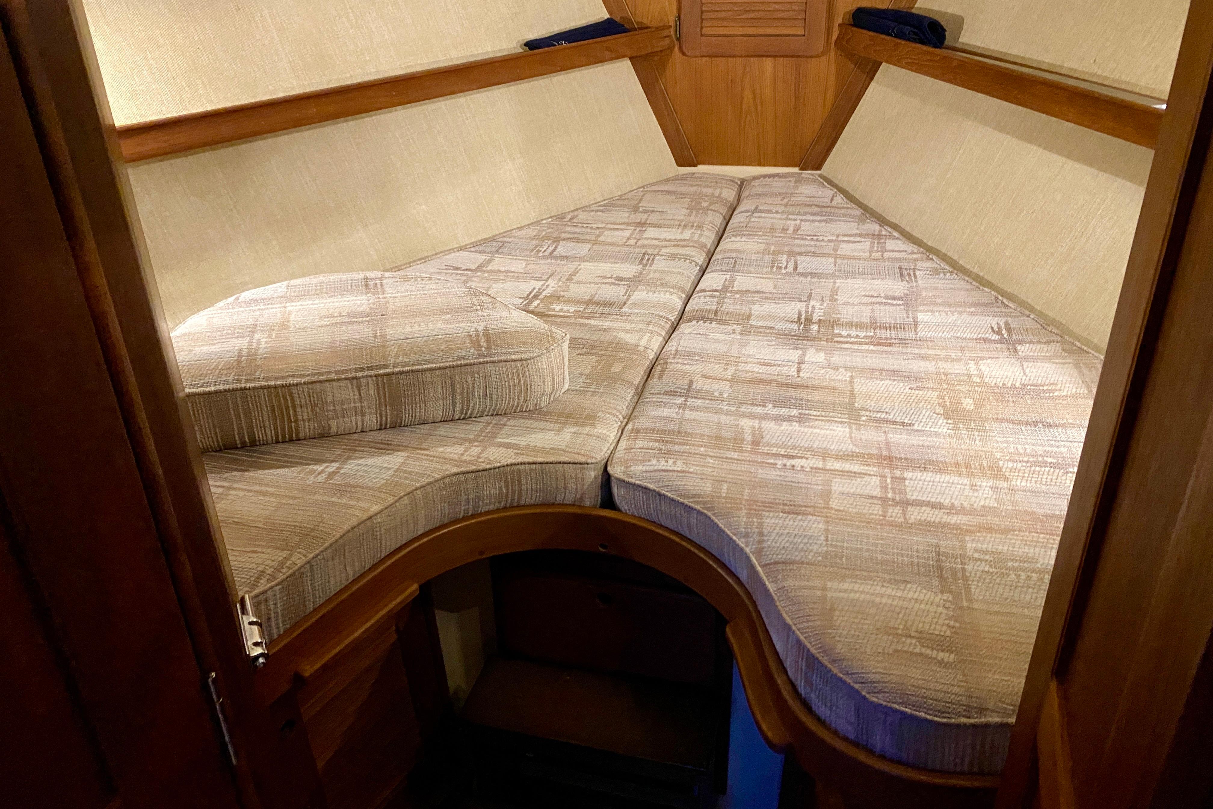 Interior cabin of a 1992 Island Packet 29 sailboat with cushioned V-berth.