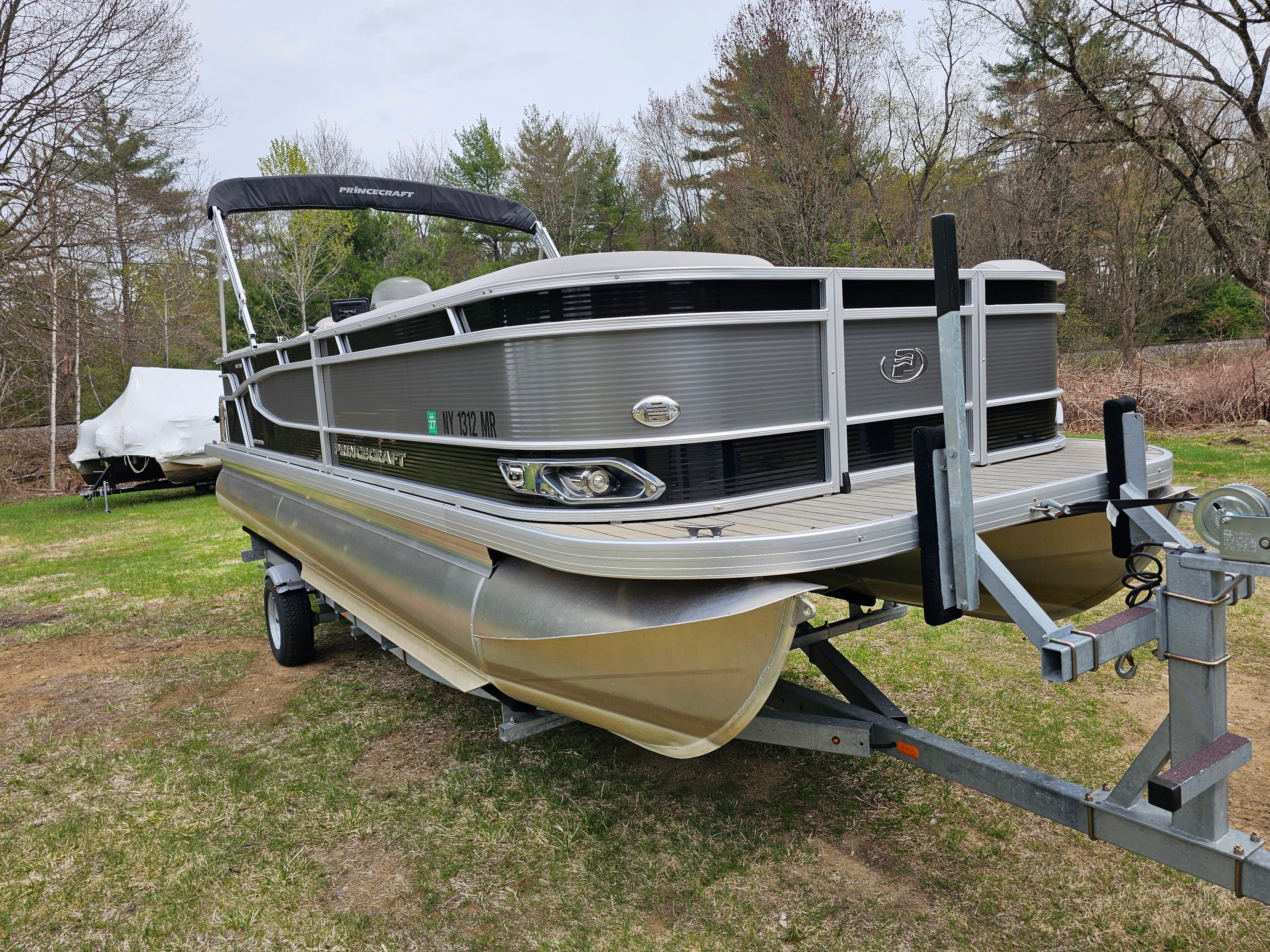 2021 Princecraft Vectra 23XT pontoon boat on trailer outdoors.