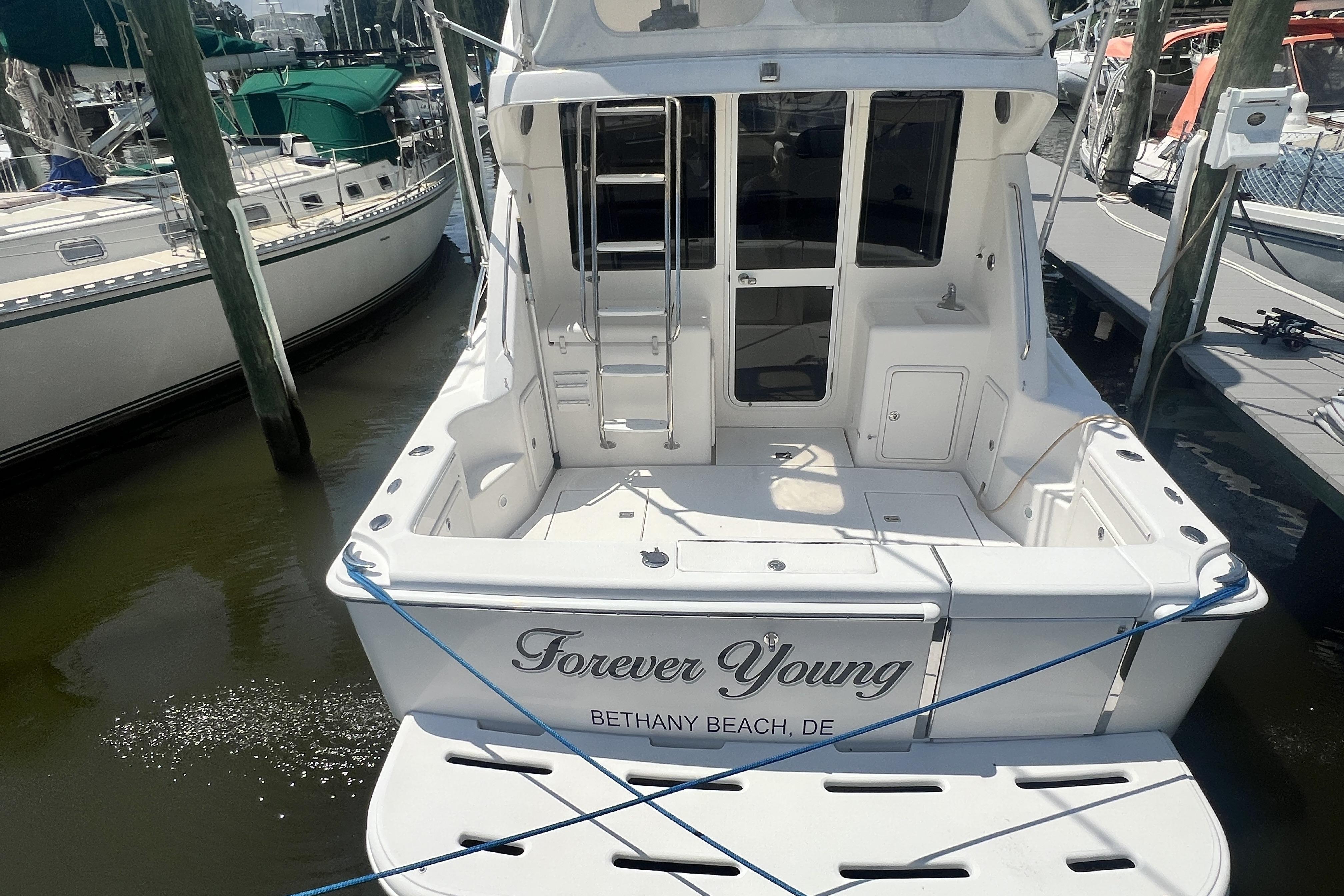 2007 Riviera 33 Flybridge yacht named "Forever Young" docked at Bethany Beach.